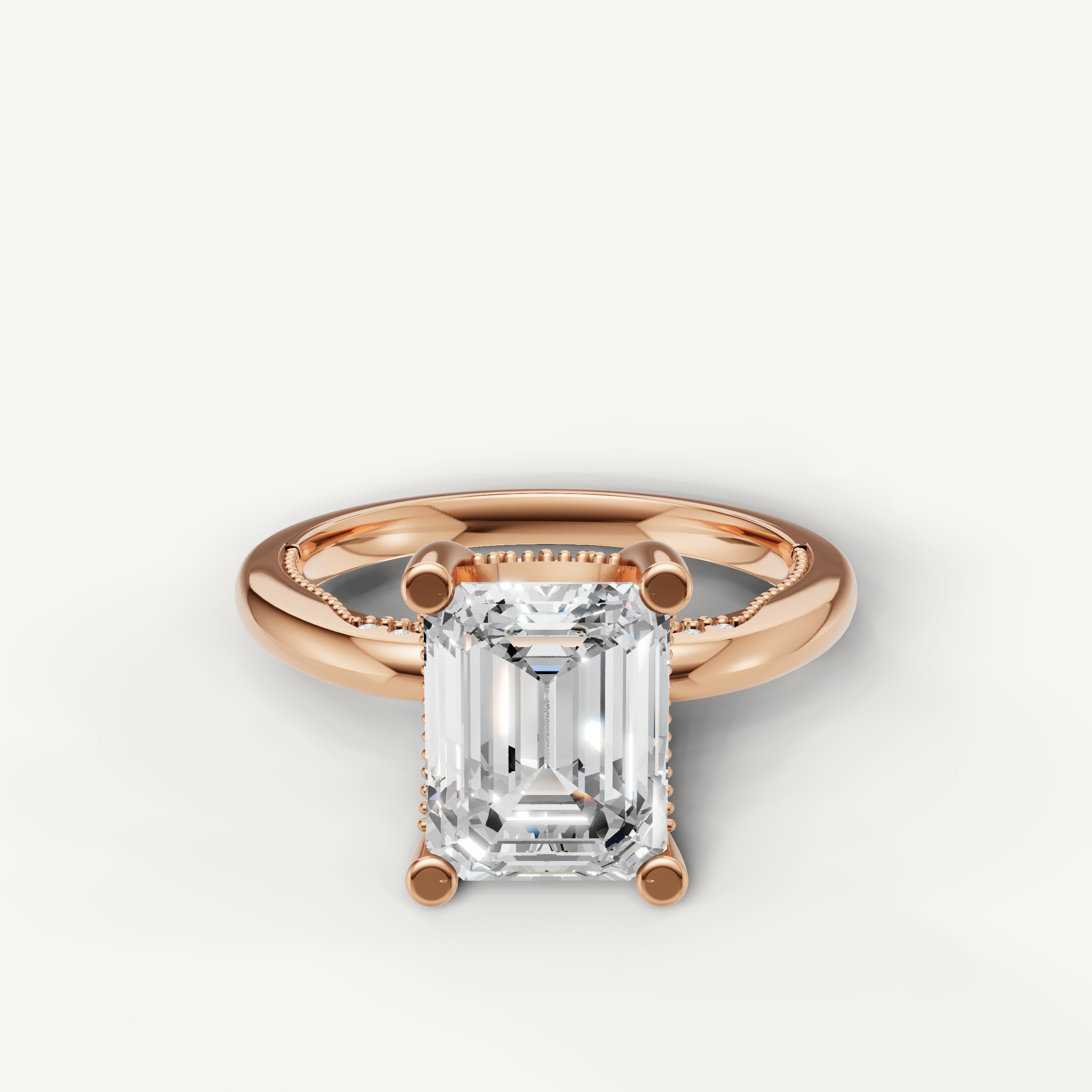 A romantic and modern engagement ring crafted in blushing 14k rose gold, featuring a striking emerald-cut diamond in a secure four-prong mount.