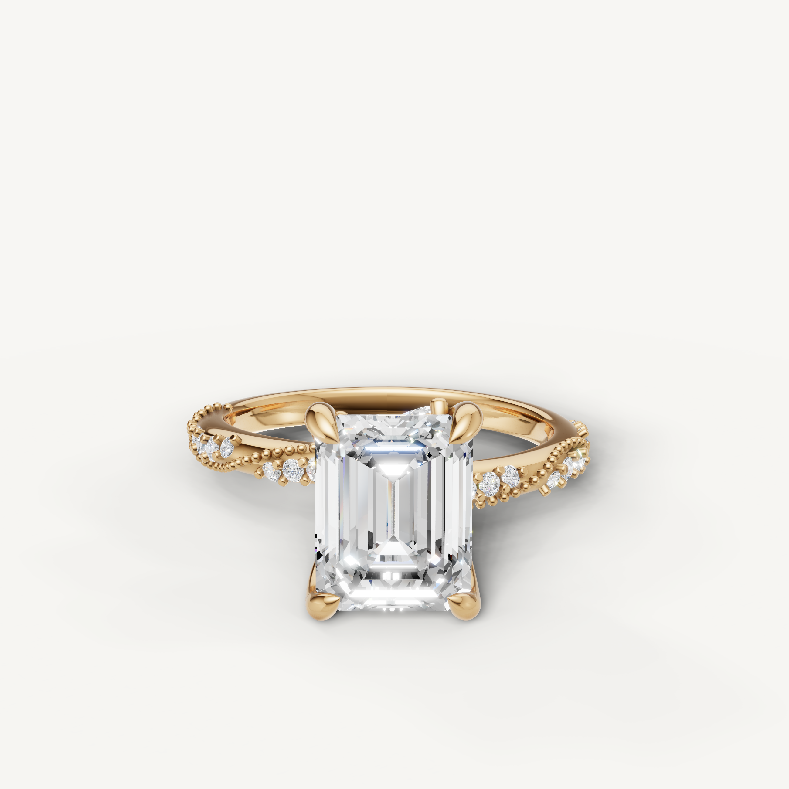 emerald cut lab grown diamond engagement ring with twisted pavé split shank yellow gold