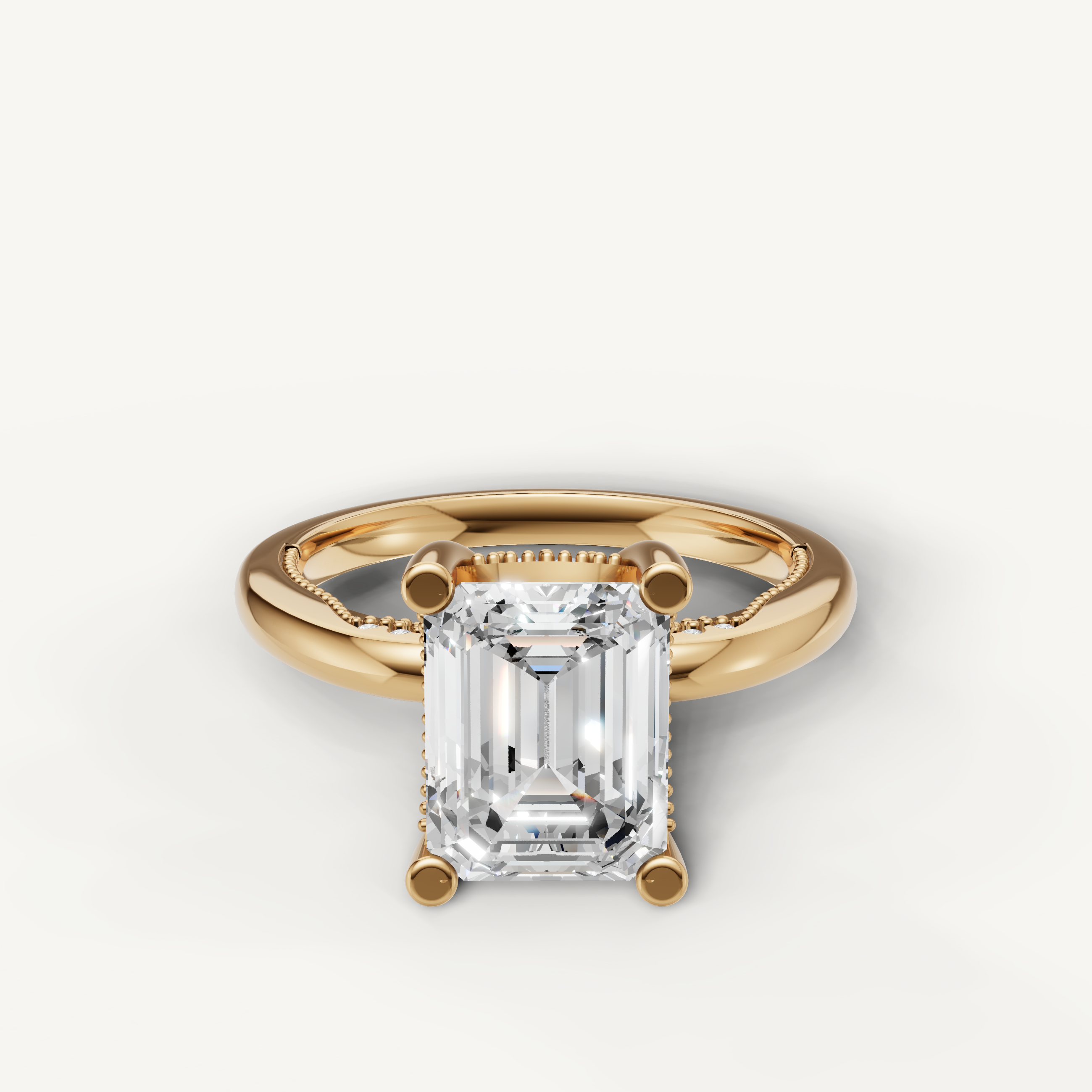 A timeless solitaire engagement ring in polished 14k yellow gold, featuring a sophisticated emerald-cut diamond in a classic four-prong setting.