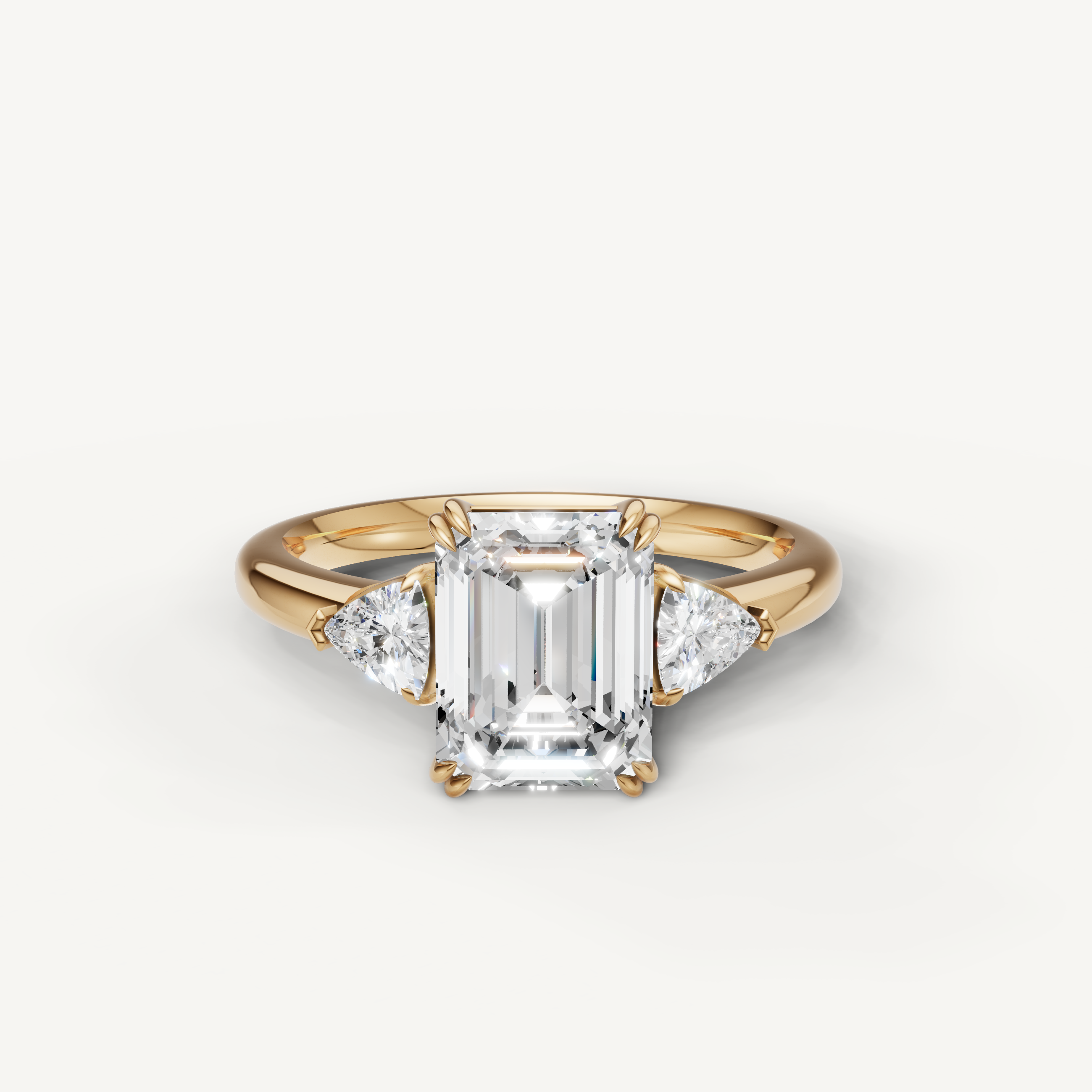 emerald cut lab grown diamond engagement ring with trillion side stones in 14k yellow gold