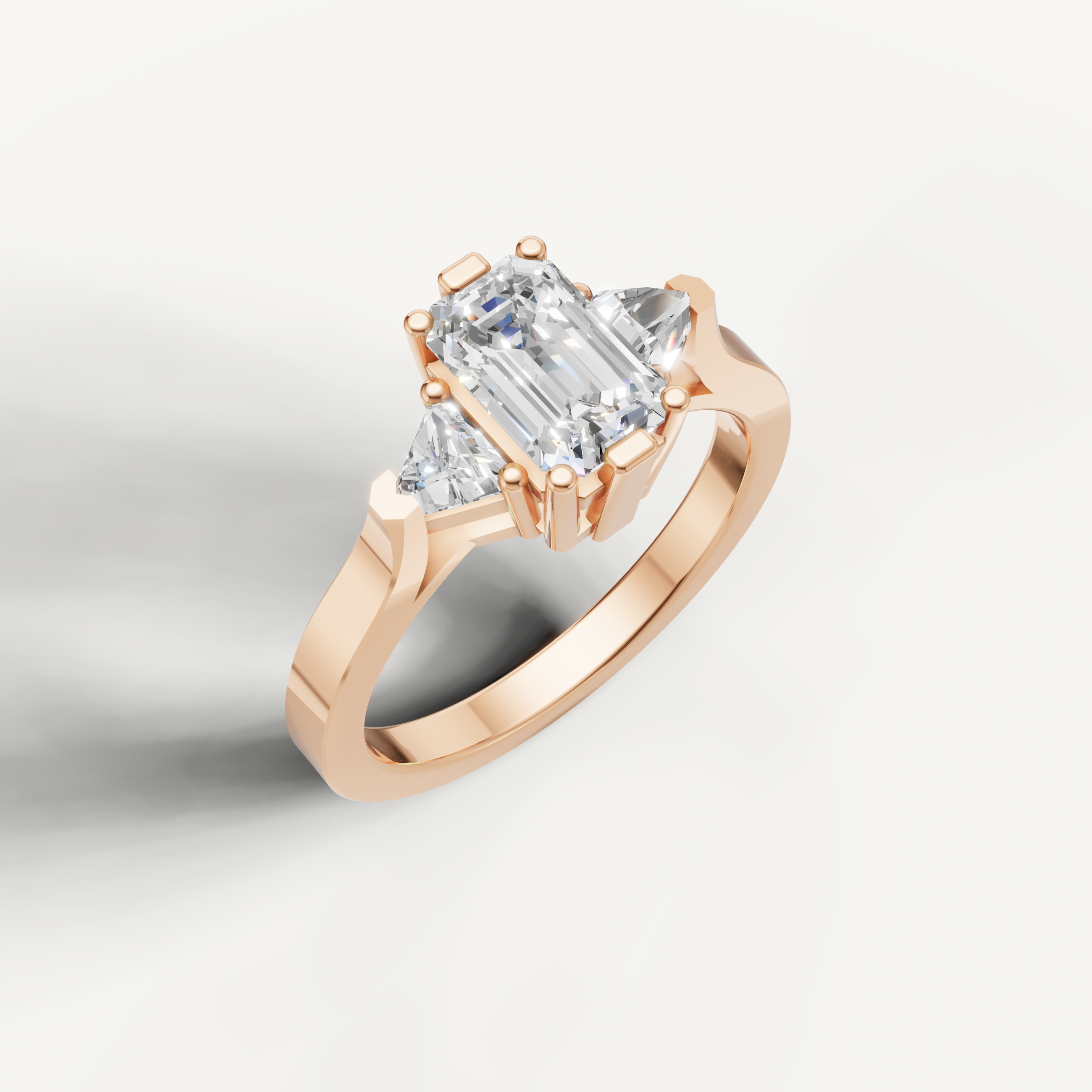 Modern emerald cut diamond ring in rose gold with sleek polished band.