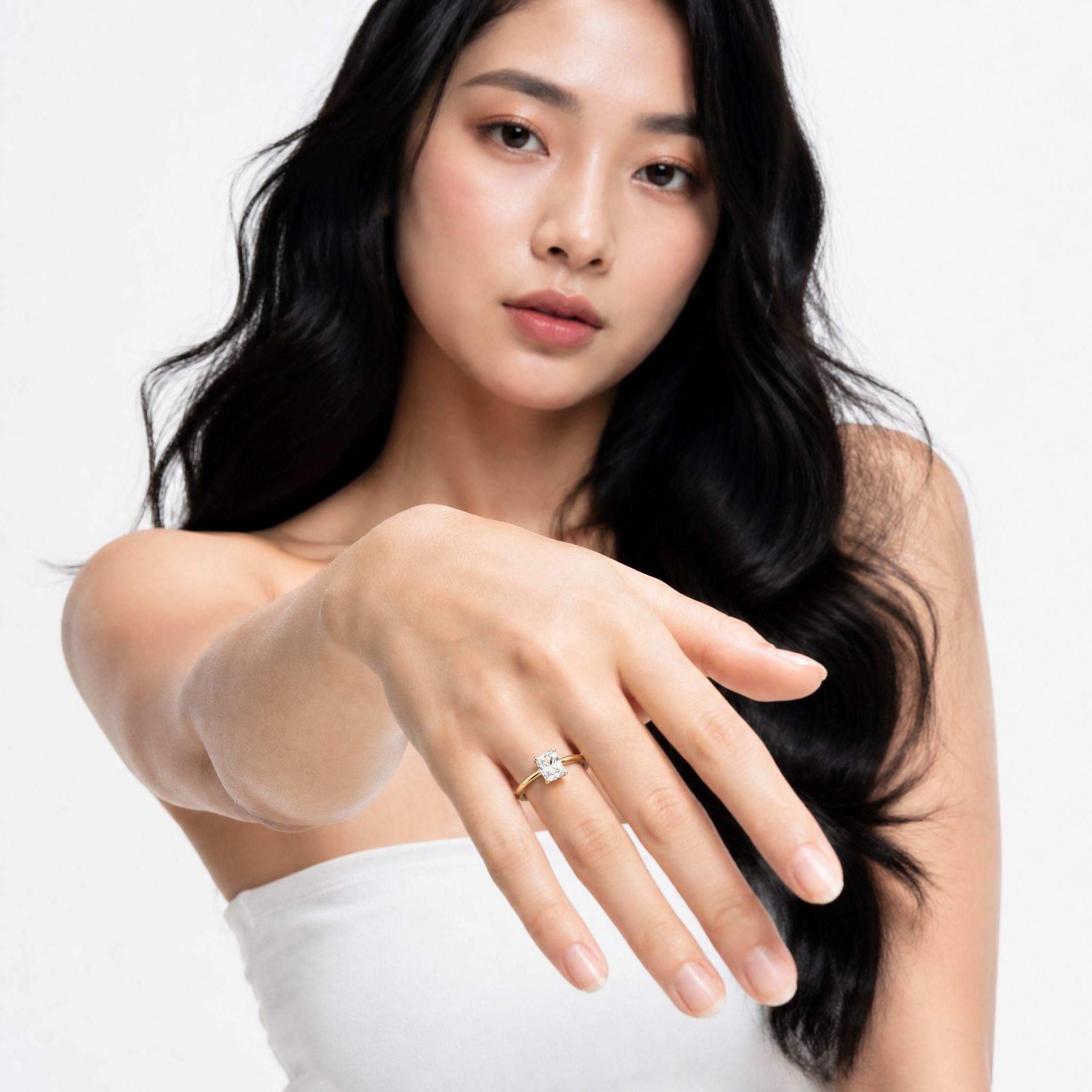 Sophisticated model Natalia showcasing a Raul Diamonds princess cut engagement ring, highlighting the sharp square silhouette and the sparkling hidden halo collar detail