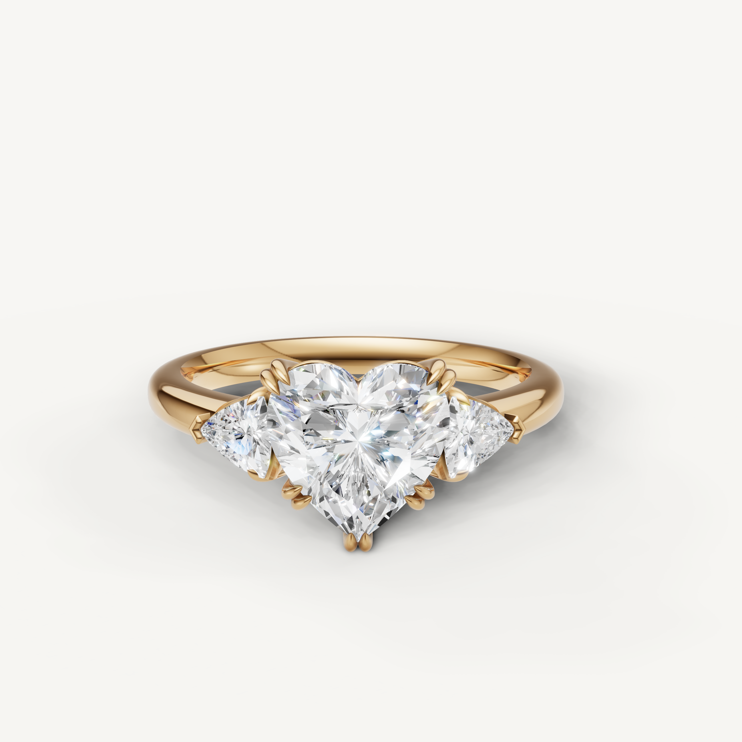 heart shaped lab grown diamond engagement ring with trillion side stones in 14k yellow gold