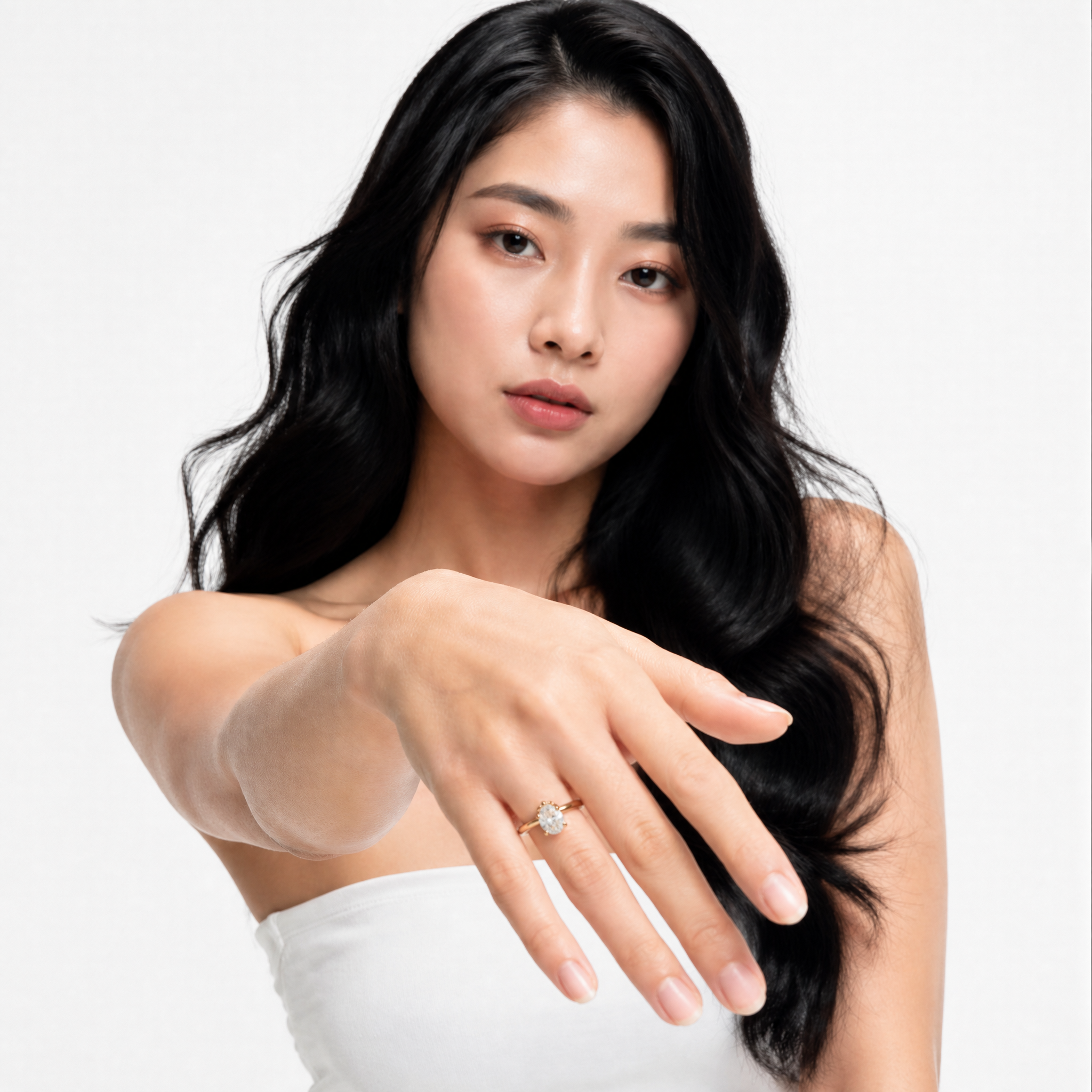Sophisticated model Stella wearing a Raul Diamonds pear-cut engagement ring, showcasing the elegant teardrop silhouette and the sparkling hidden halo collar