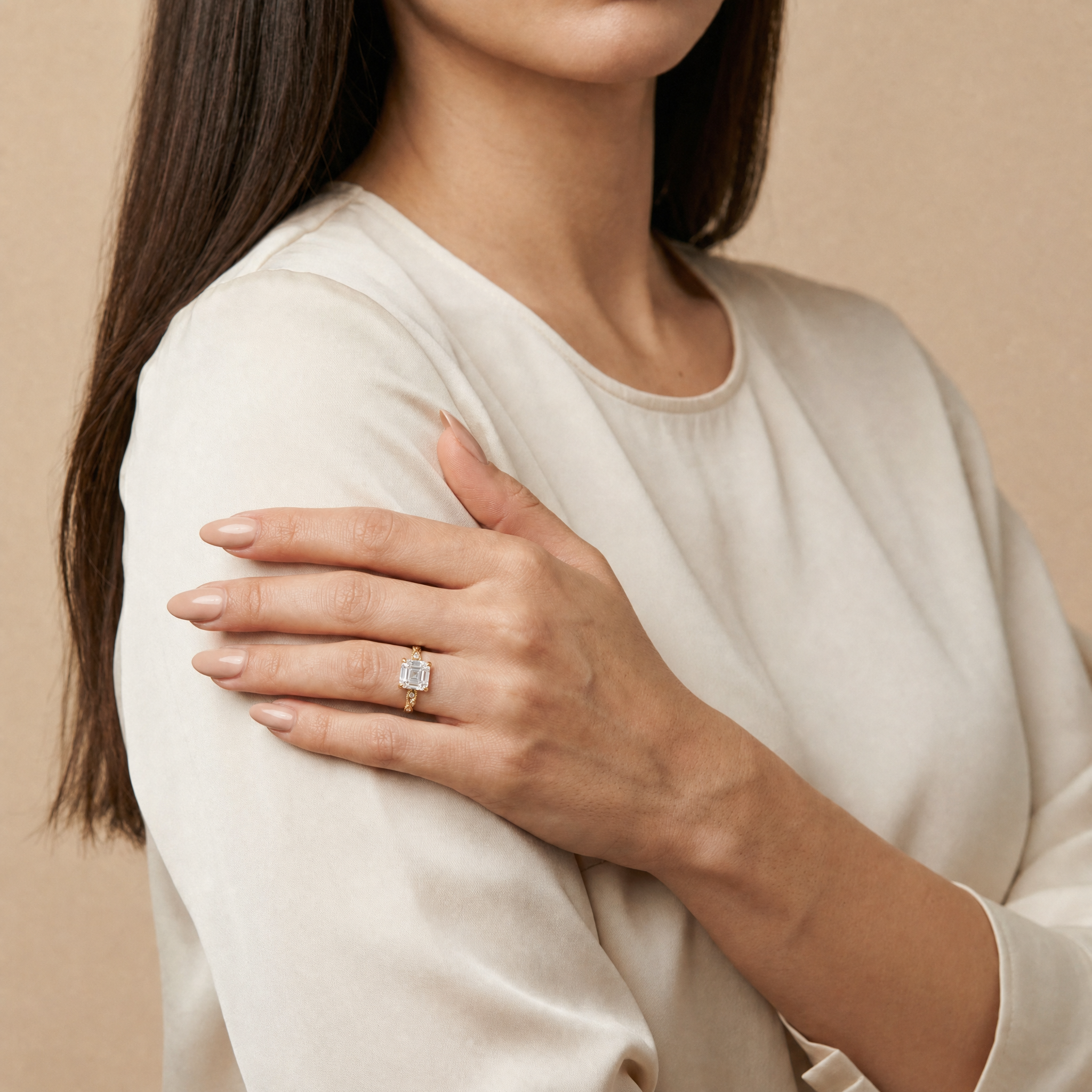 Model wearing Raul Diamonds asscher cut lab grown diamond engagement ring in 14K gold with elegant twisted pavé band