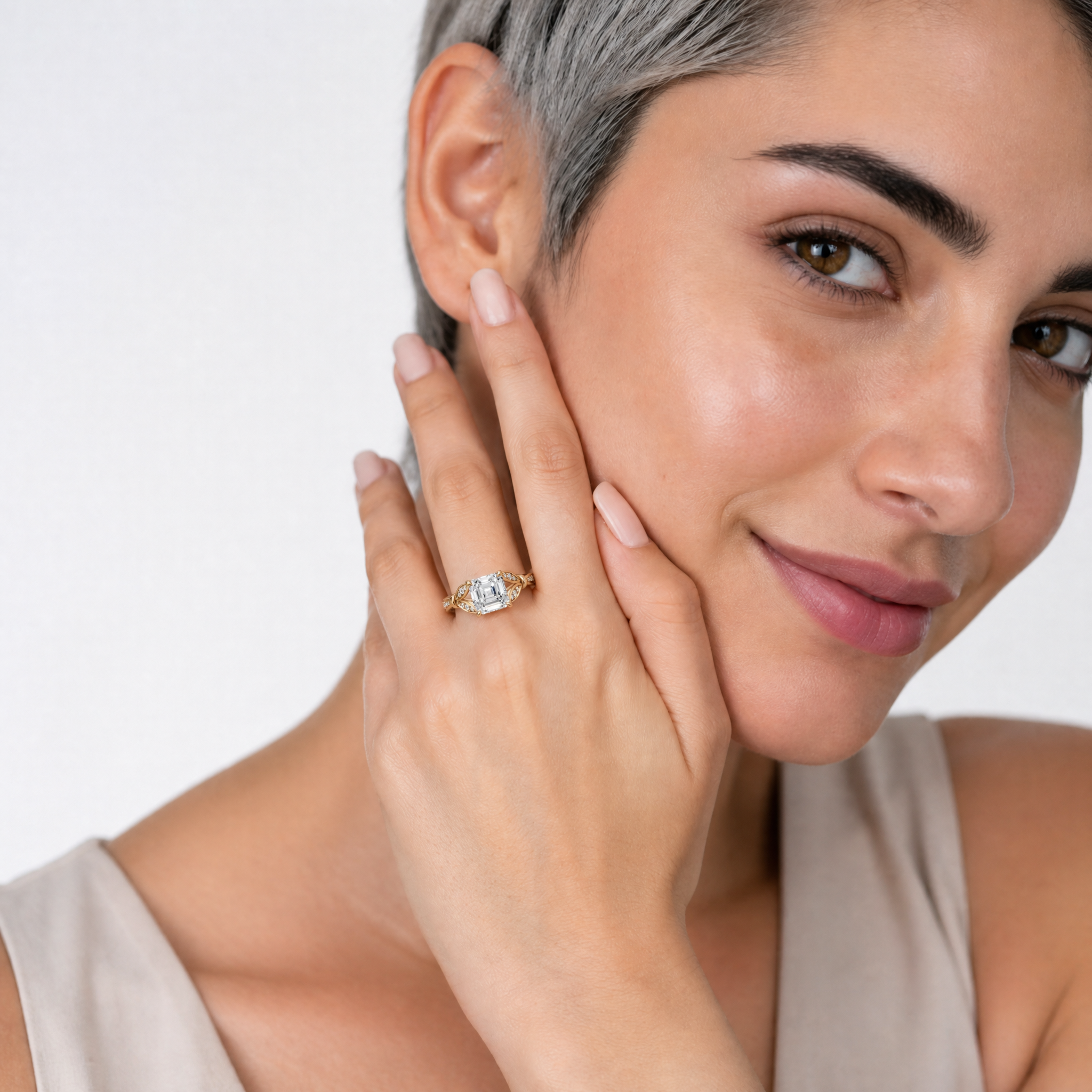 Model wearing Raul Diamonds Asscher cut lab grown diamond engagement ring in 14K gold with elegant pavé detailing