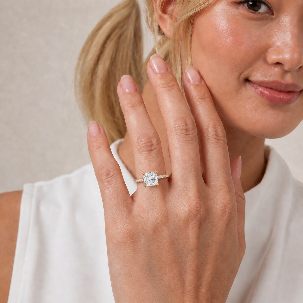 Model wearing a cushion cut lab grown diamond pavé engagement ring in 14K gold by Raul Diamonds