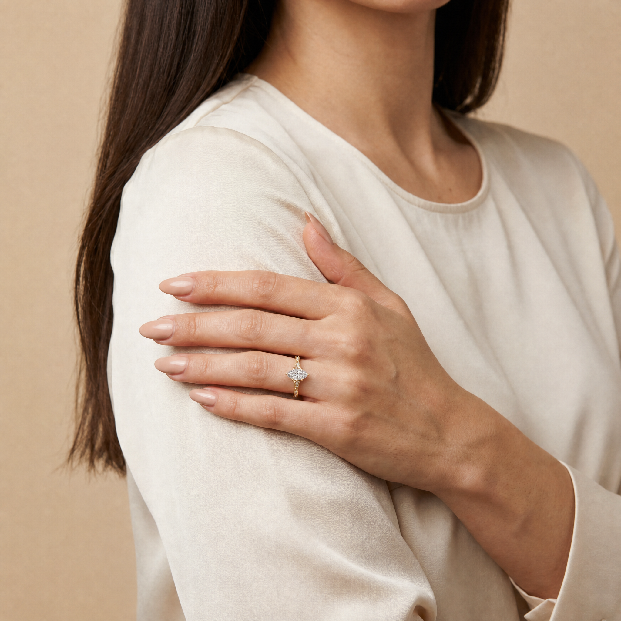 Model wearing Raul Diamonds marquise cut lab grown diamond engagement ring in 14K gold with elegant twisted pavé band