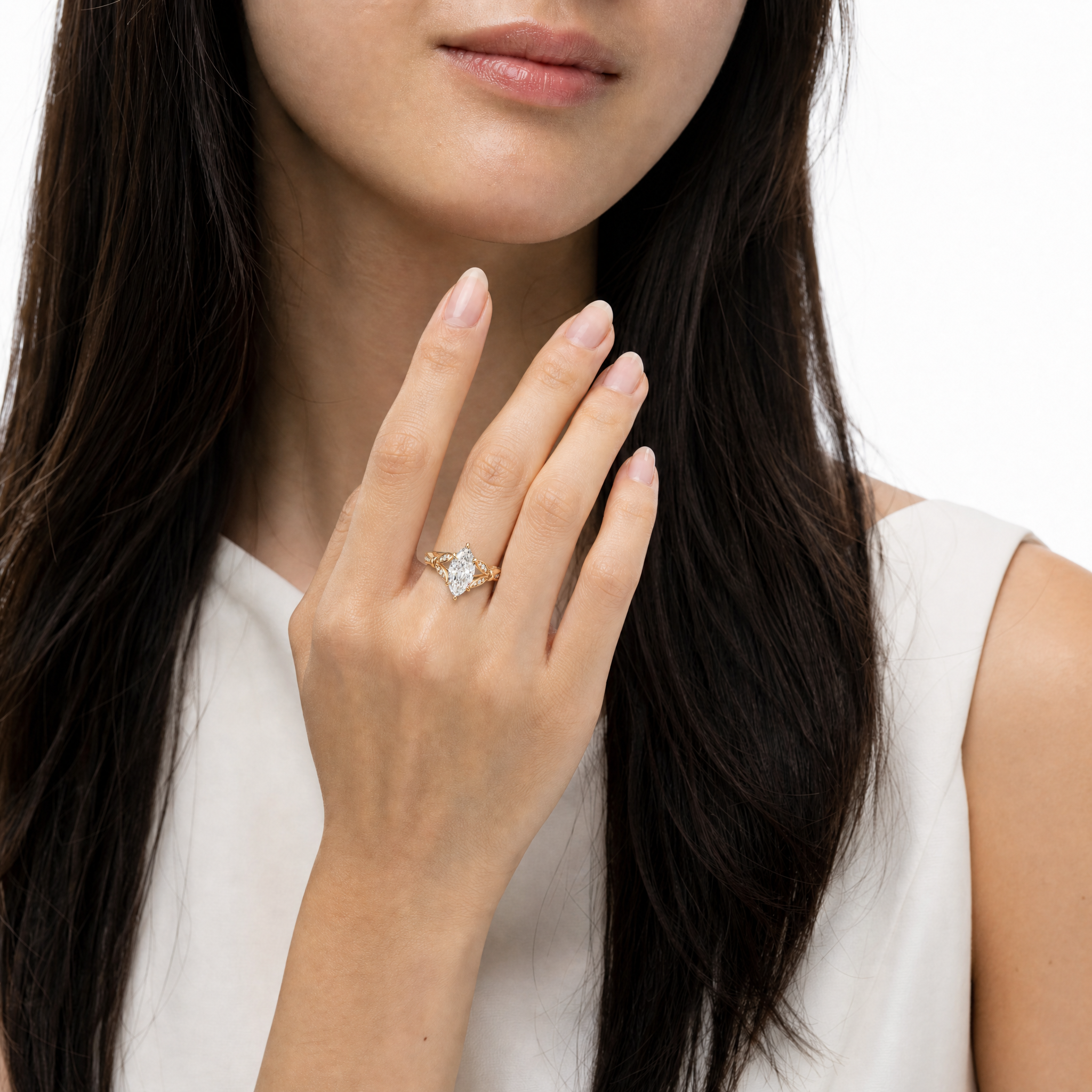 Model wearing Raul Diamonds marquise cut lab grown diamond engagement ring in 14K gold with elegant pavé detailing