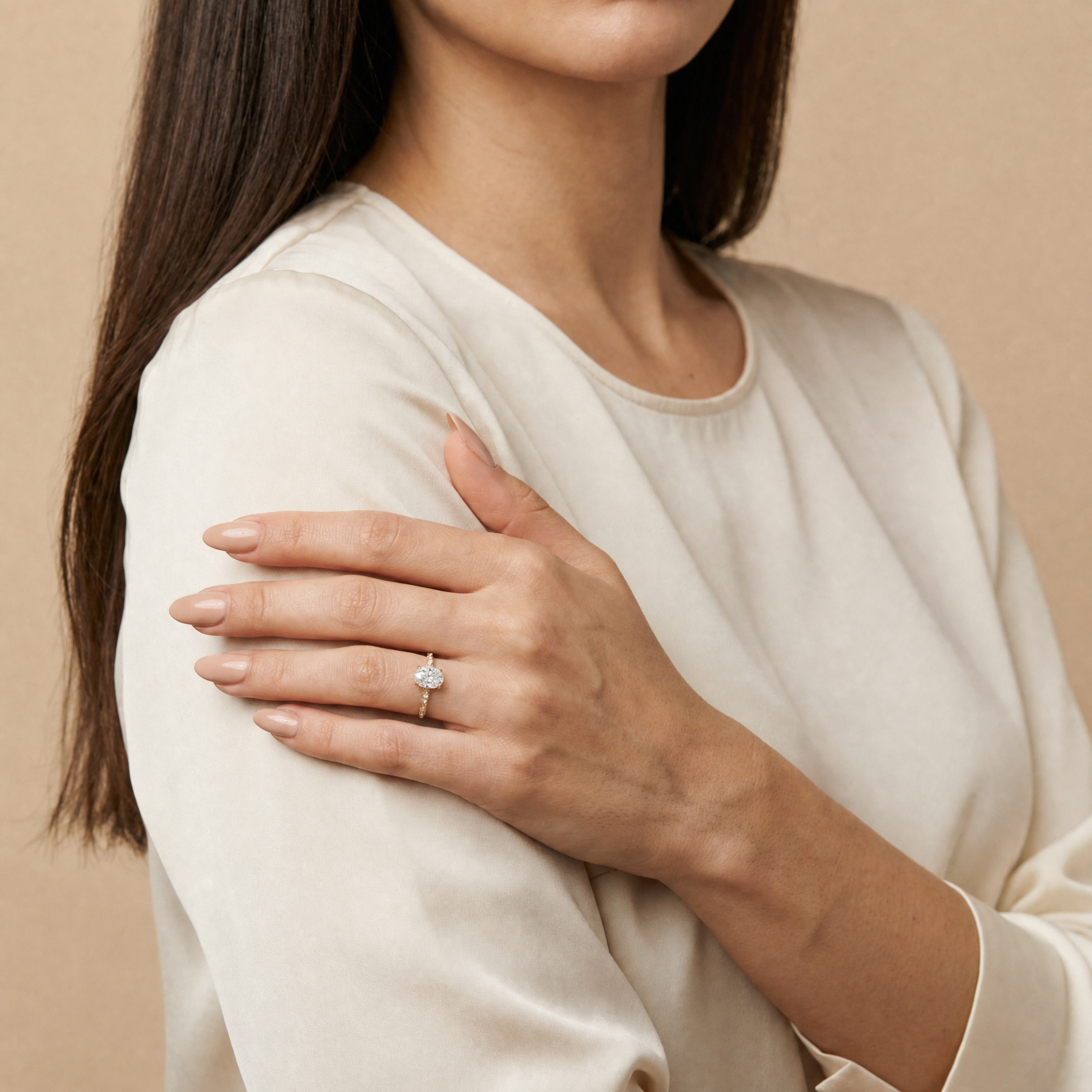 Model wearing Raul Diamonds oval cut lab grown diamond engagement ring in 14K gold with elegant twisted pavé band