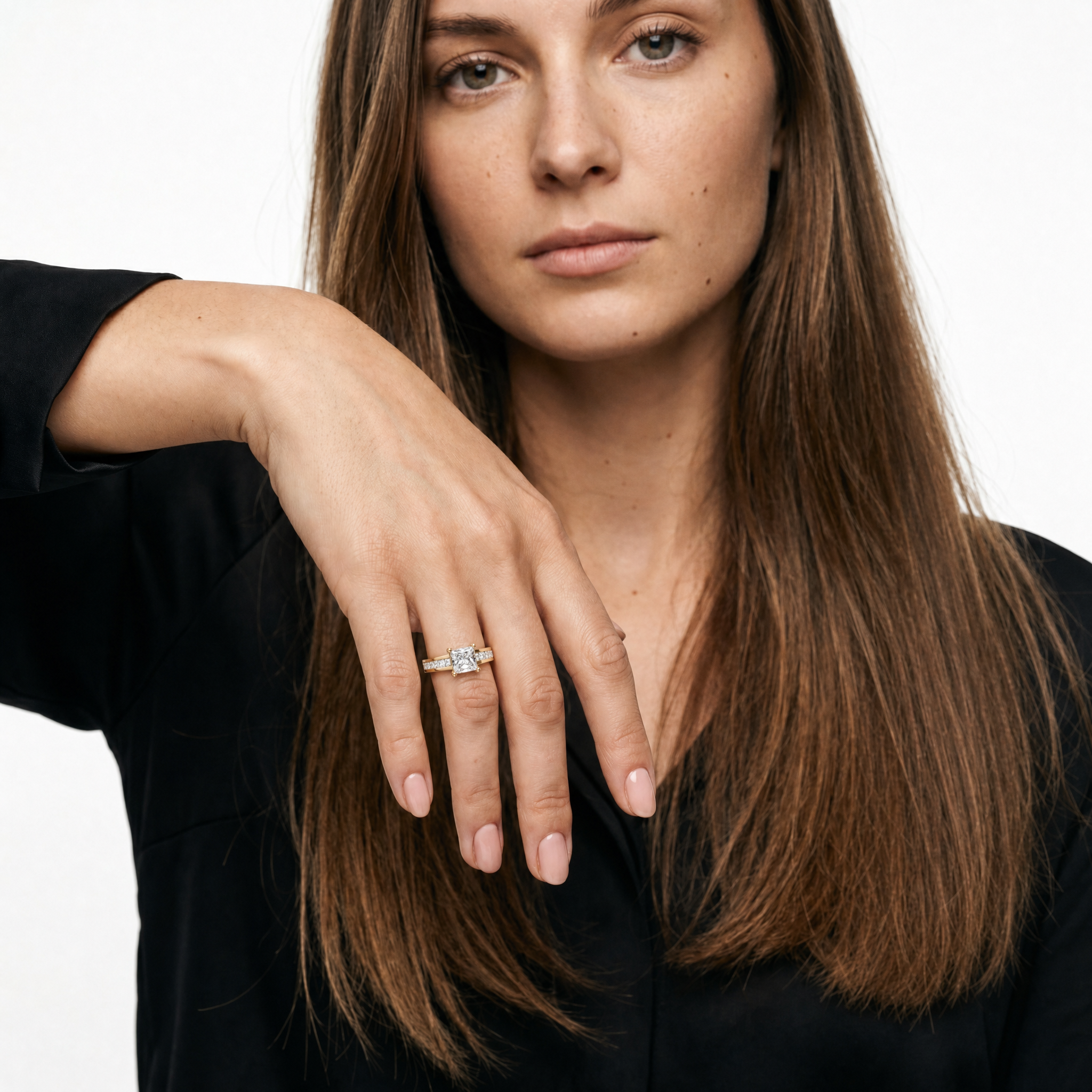 Model wearing Raul Diamonds princess cut diamond engagement ring in yellow gold with channel set side diamonds