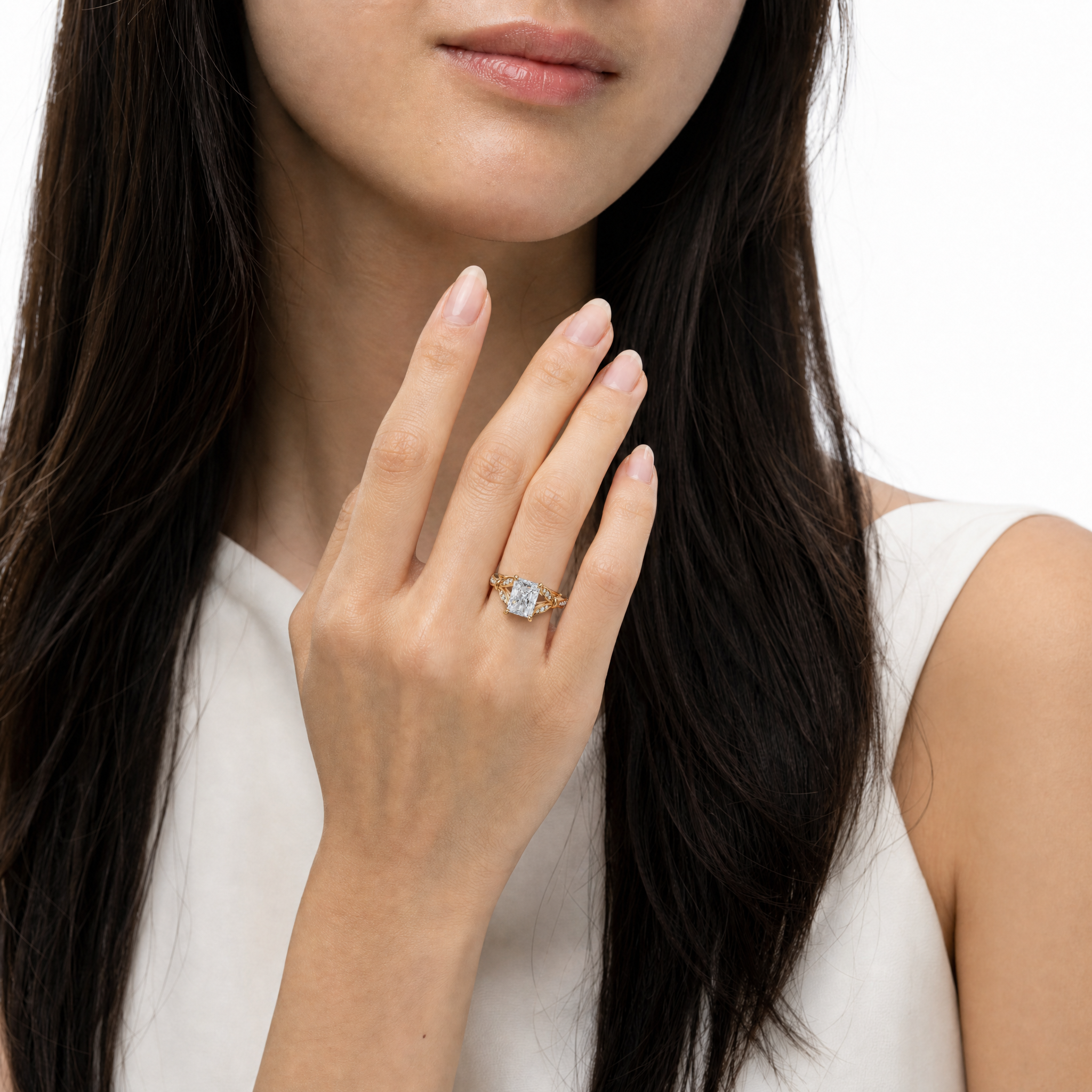 Model wearing Raul Diamonds radiant cut lab grown diamond engagement ring in 14K gold with elegant pavé detailing