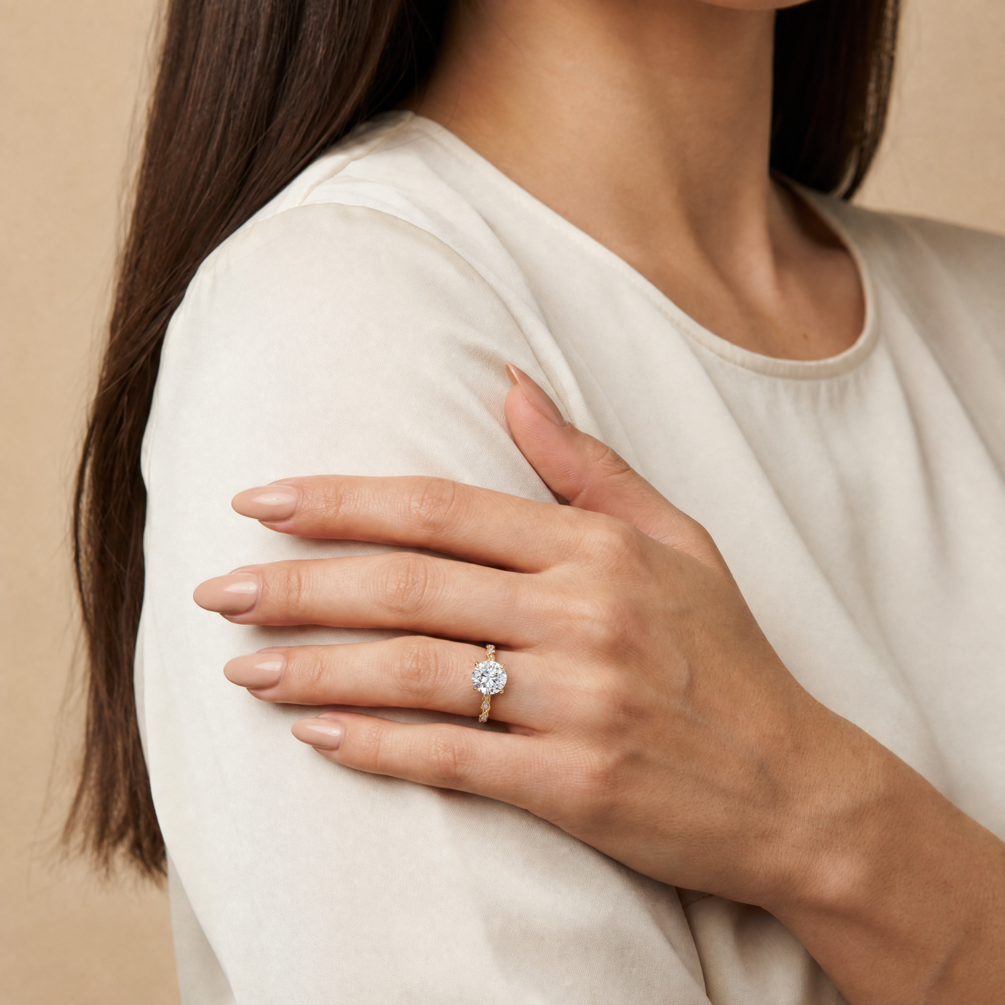 Model wearing Raul Diamonds round cut lab grown diamond engagement ring in 14K gold with elegant twisted pavé band