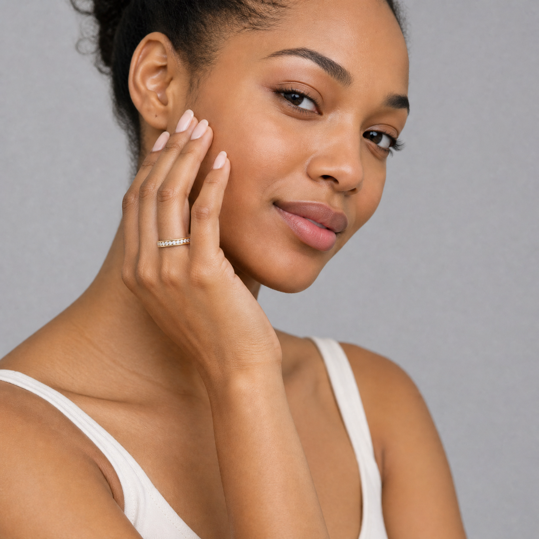 Model wearing round lab grown diamond channel set wedding band in 14K gold by Raul Diamonds