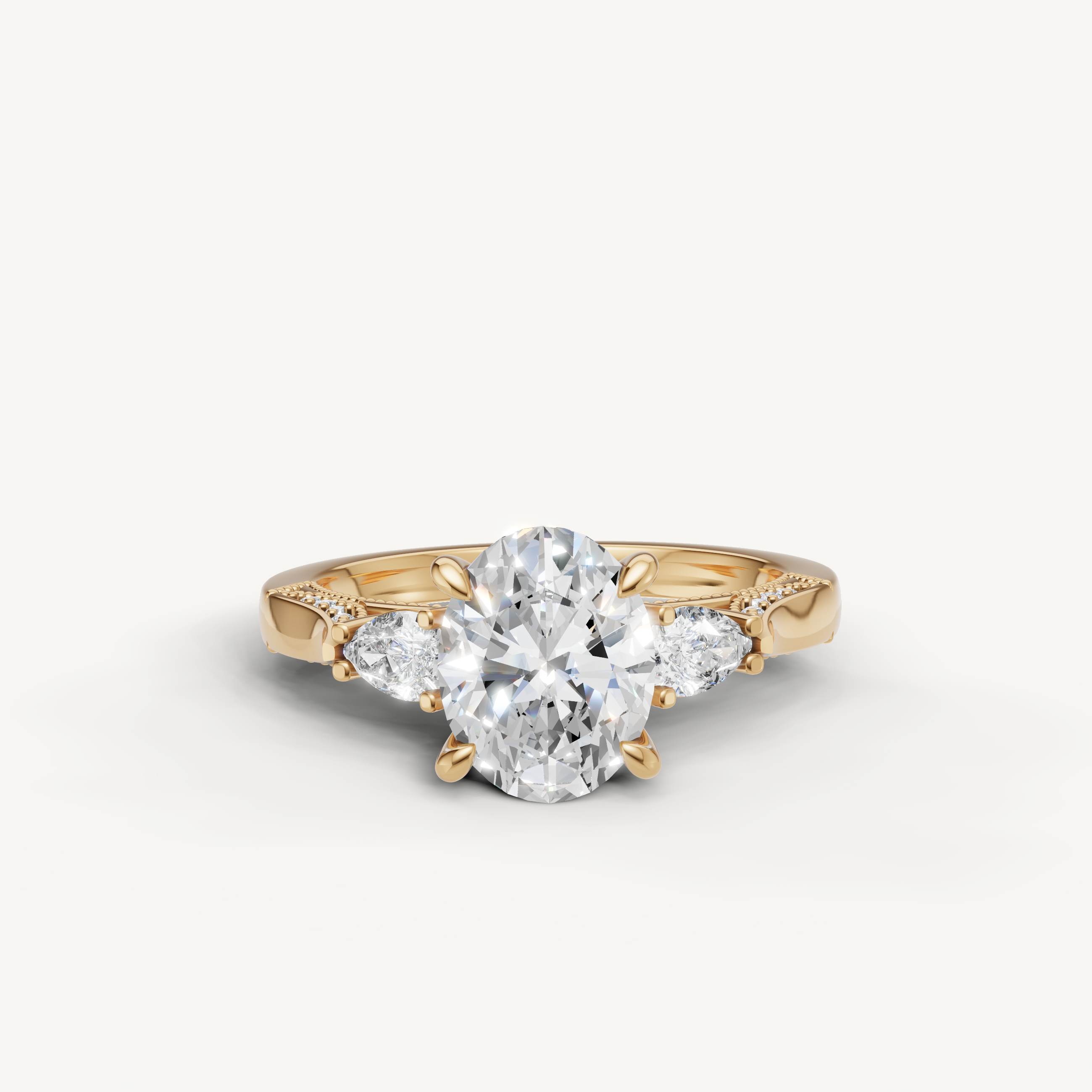 Oval cut lab grown diamond three stone ring with pear side stones yellow gold engagement ring