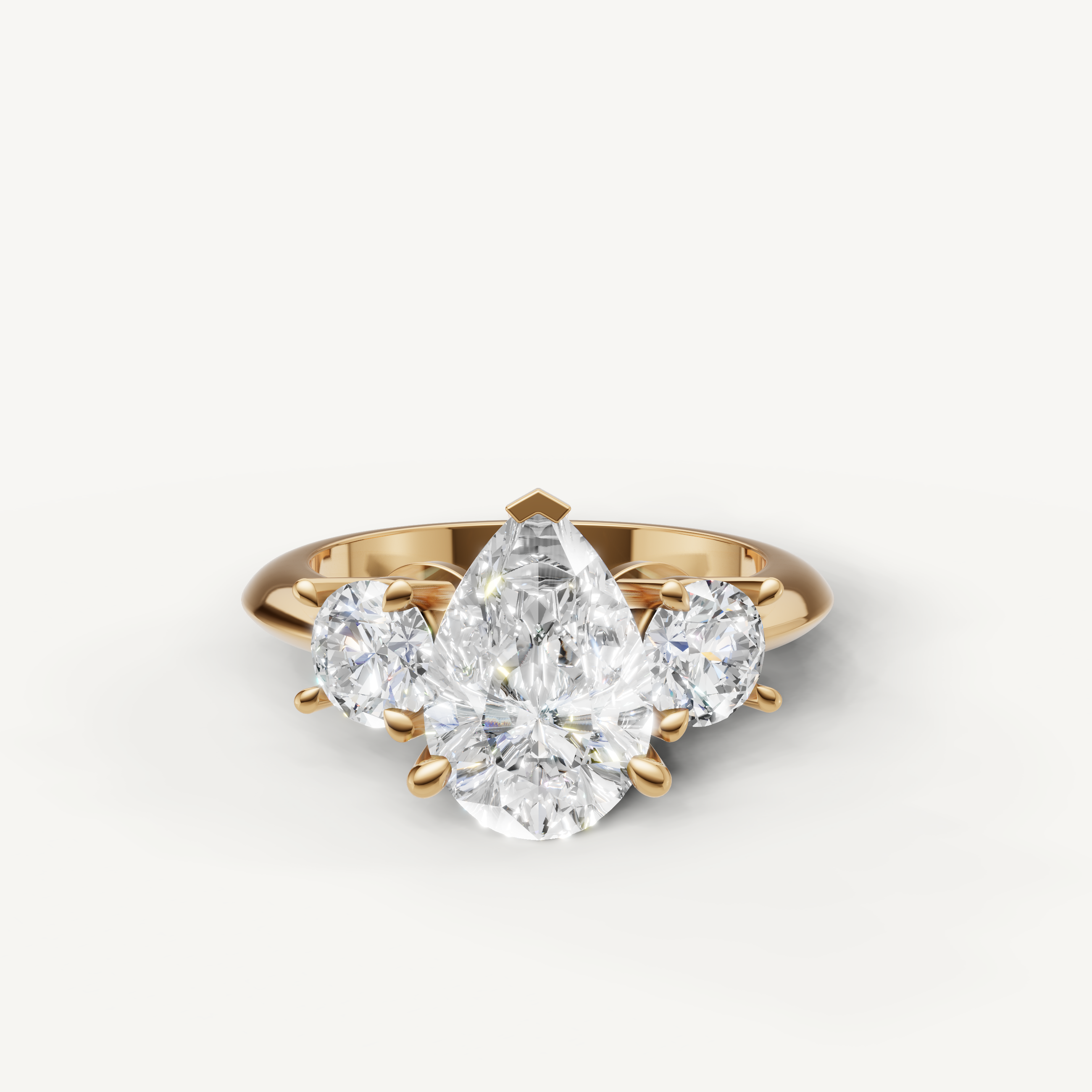 Pear cut three stone lab grown diamond engagement ring in 14K yellow gold