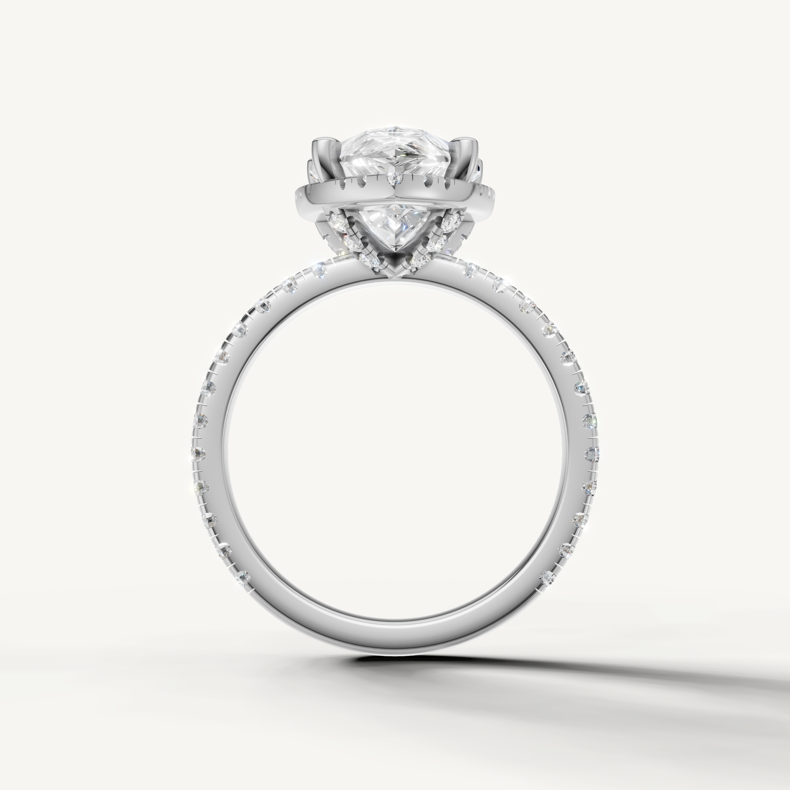 Pear shaped diamond ring with pavé band and hidden halo white gold elegant design