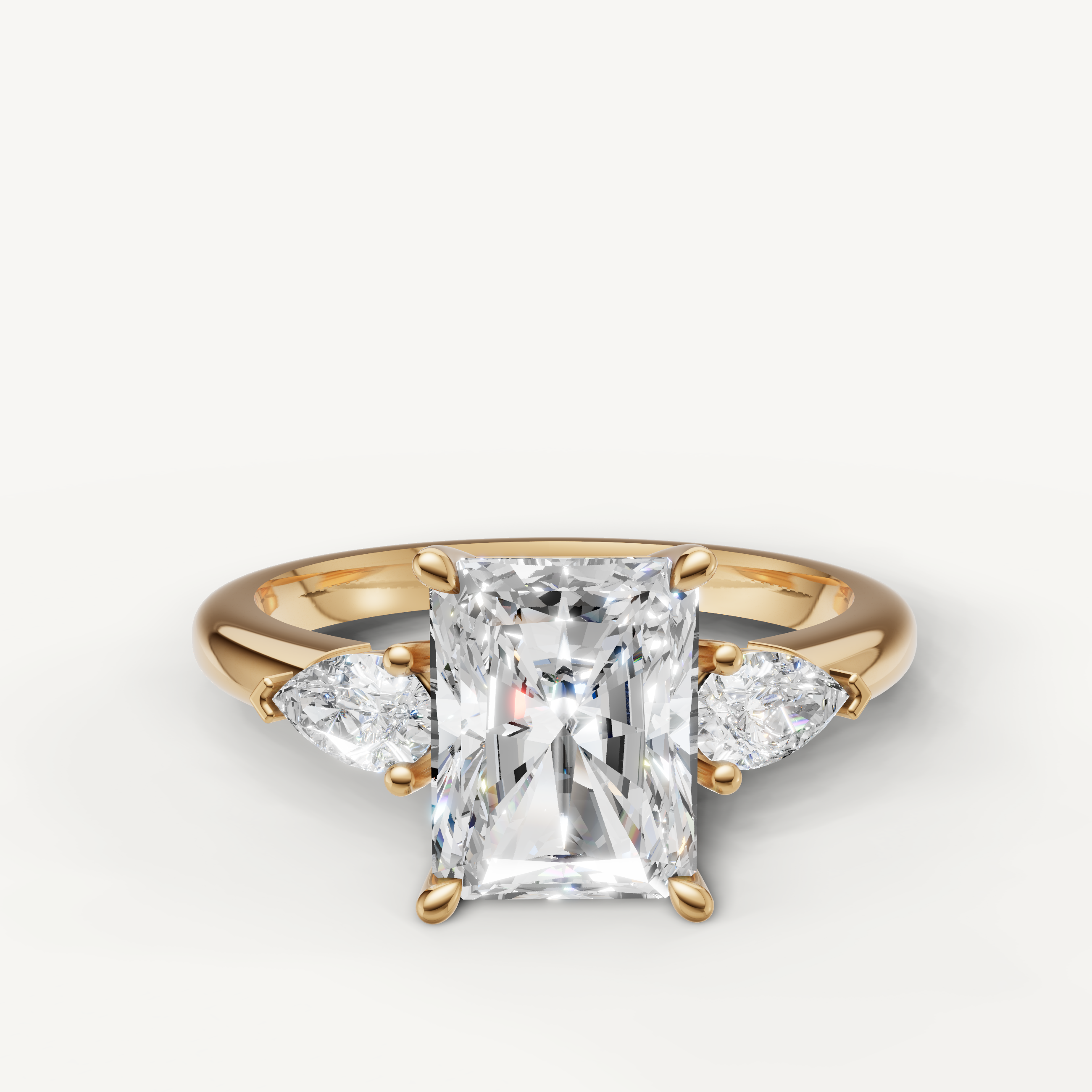 radiant cut lab grown diamond engagement ring with pear side stones in 14k yellow gold