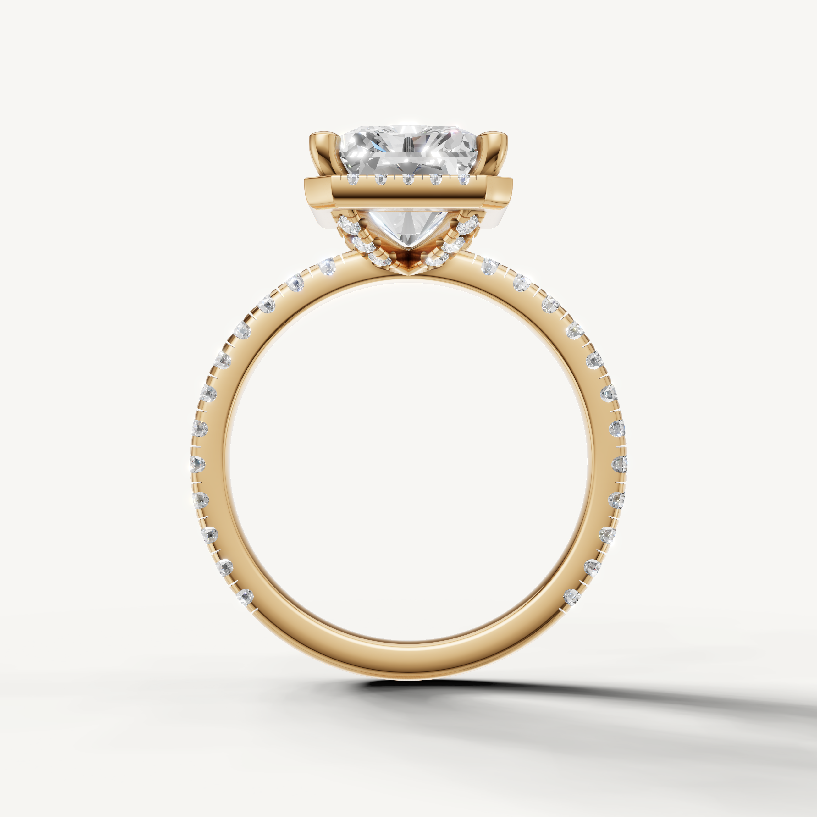 Radiant shape diamond engagement ring with pavé band and hidden halo yellow gold