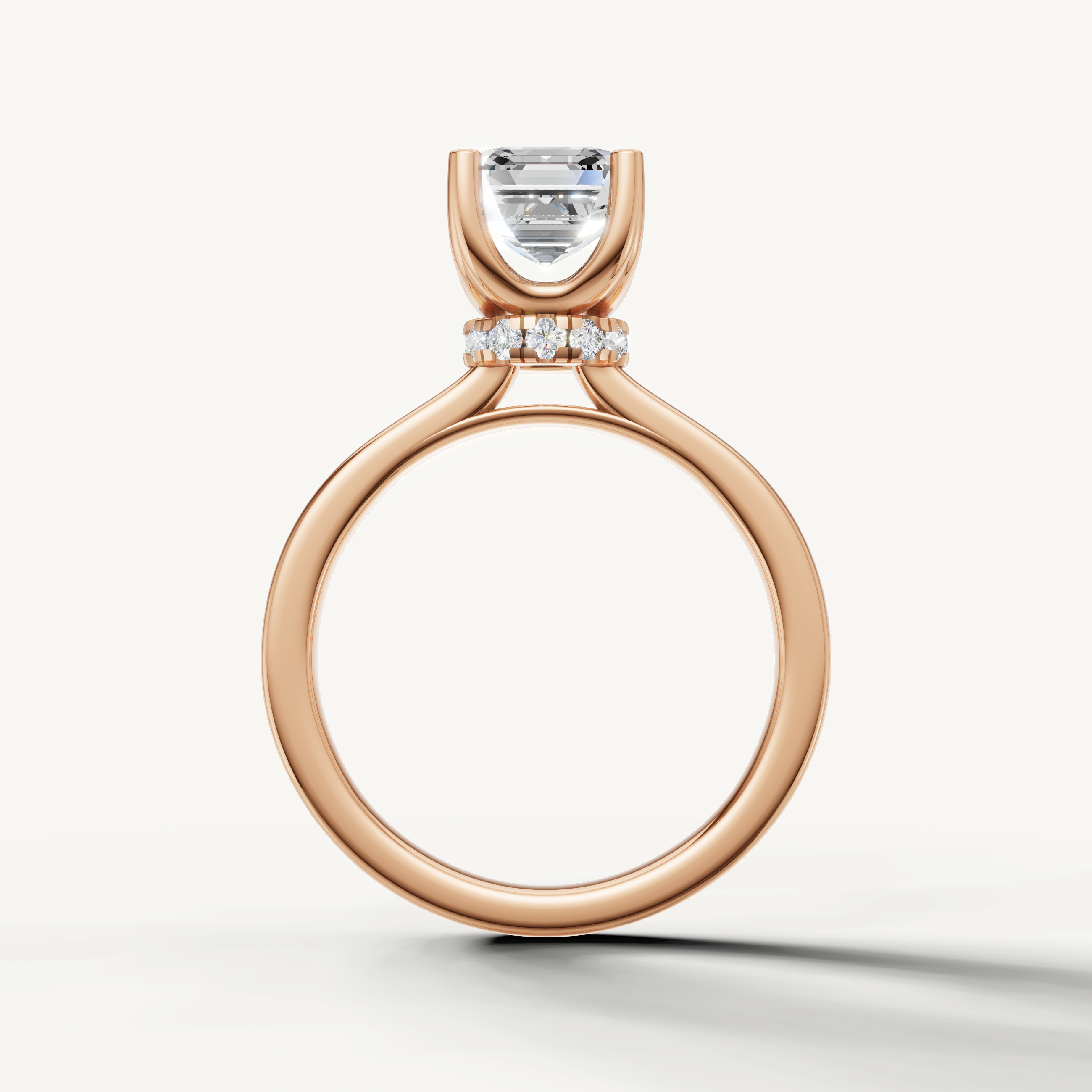 A sophisticated rose gold engagement ring that beautifully frames the clarity and graceful geometry of an Asscher-cut center diamond.