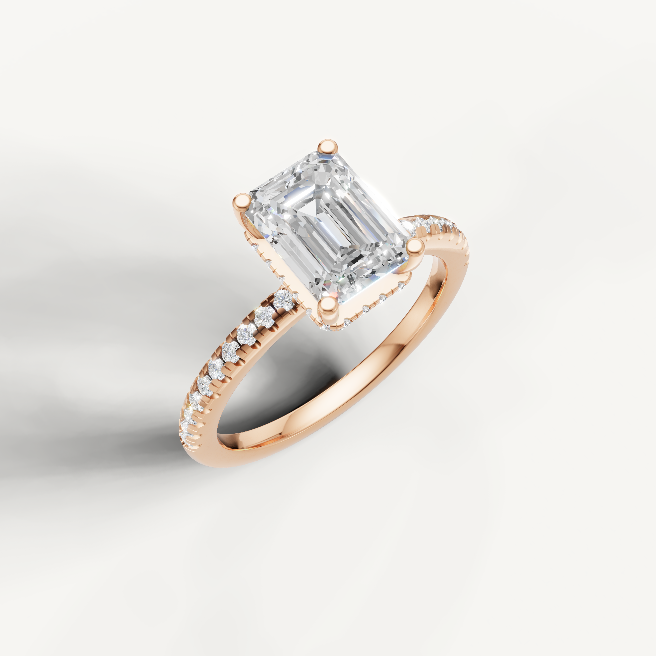 emerald cut diamond engagement ring with delicate pavé shank and hidden halo rose gold