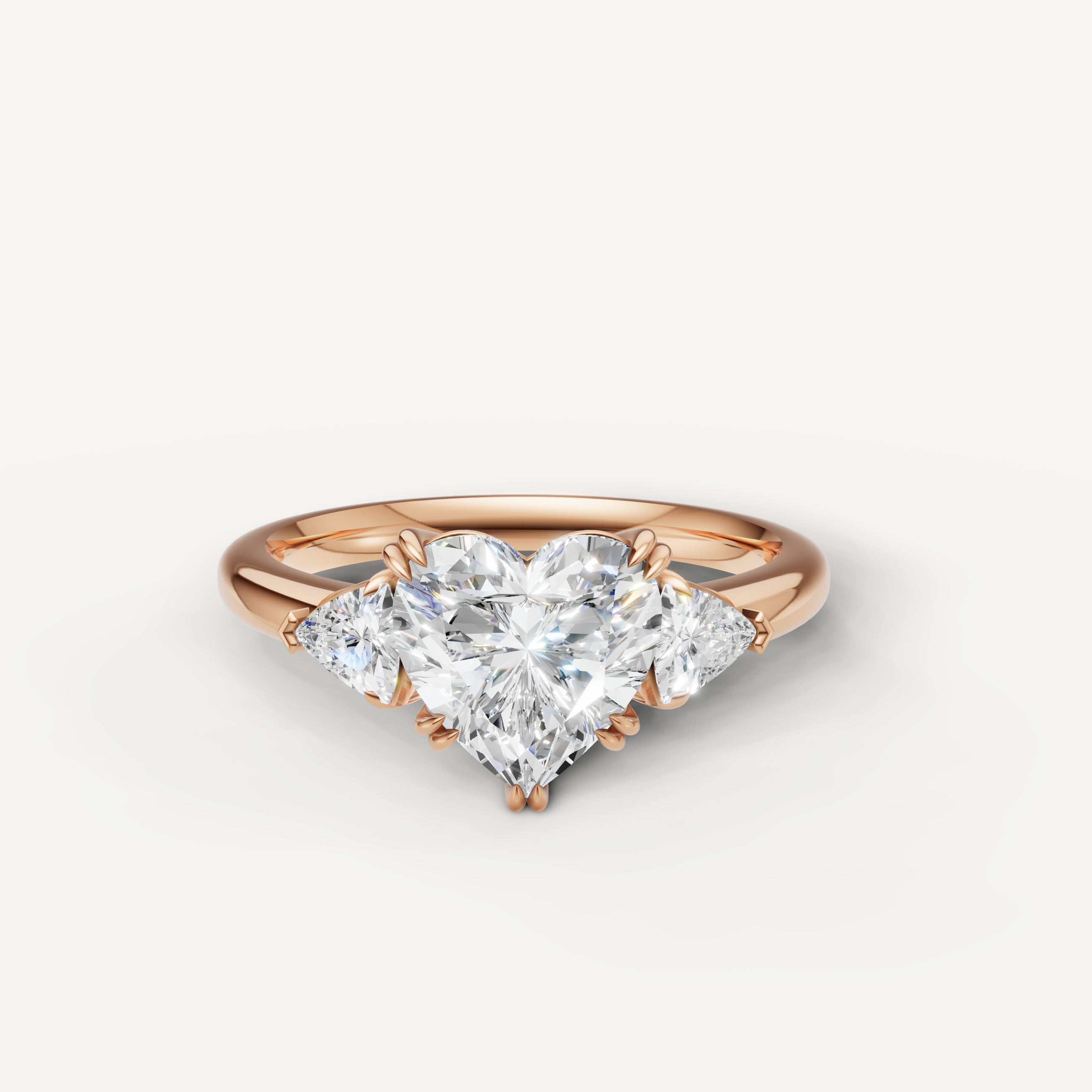 heart shaped lab grown diamond engagement ring with trillion side stones in 14k rose gold