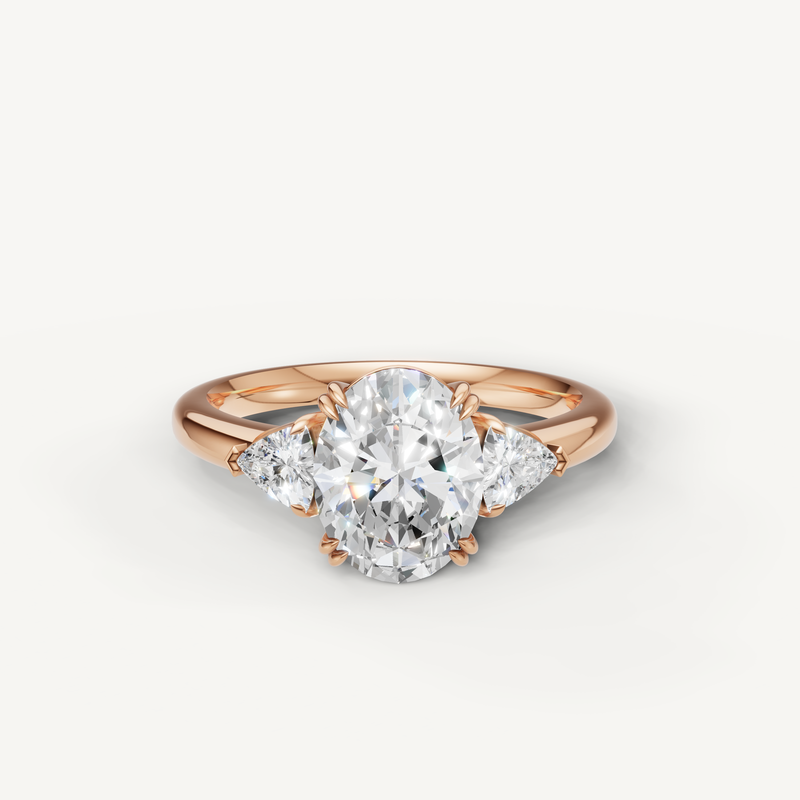 oval cut lab grown diamond engagement ring with trillion side stones in 14k rose gold