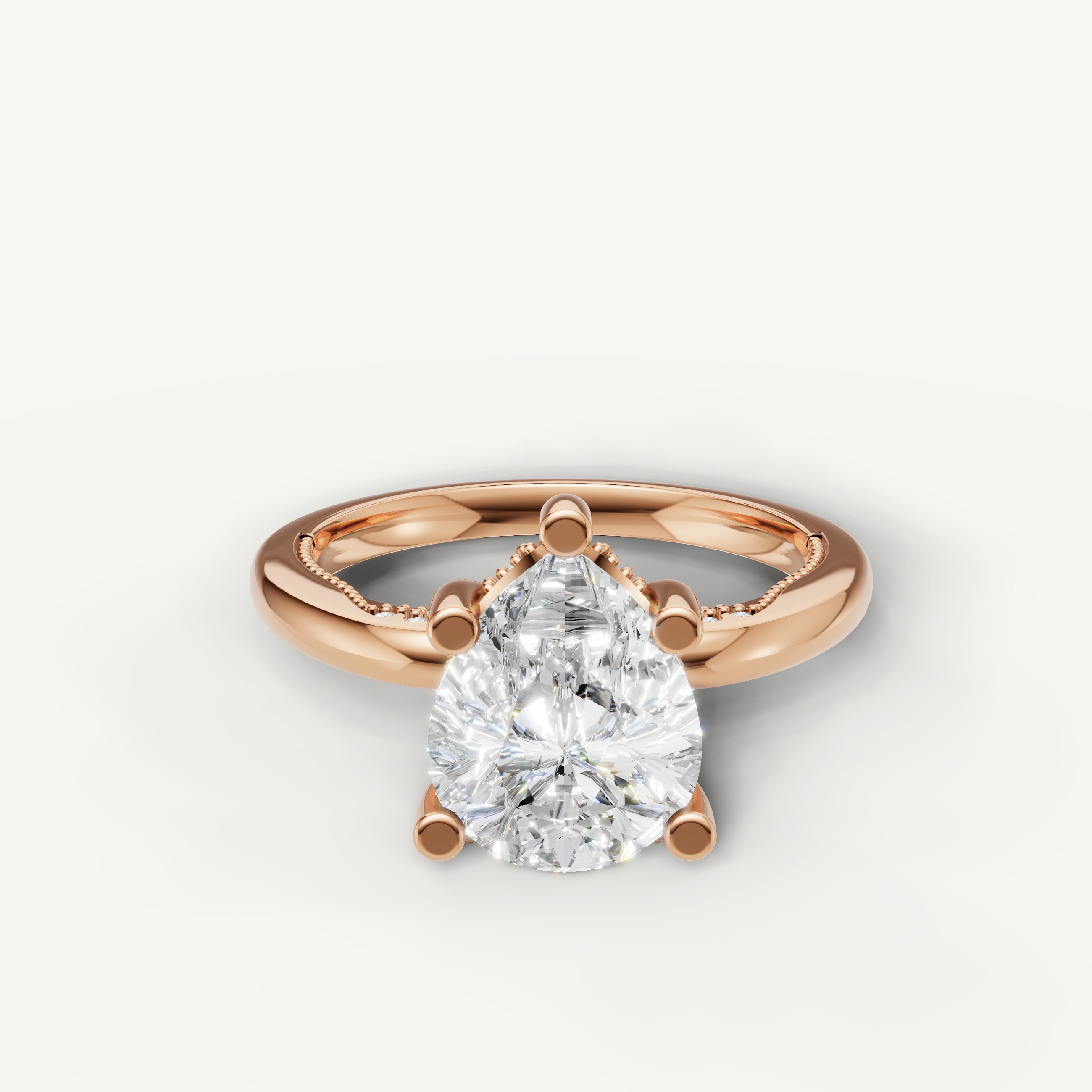 A romantic and modern engagement ring crafted in blushing 14k rose gold, featuring a striking pear-cut diamond held by delicate prongs.