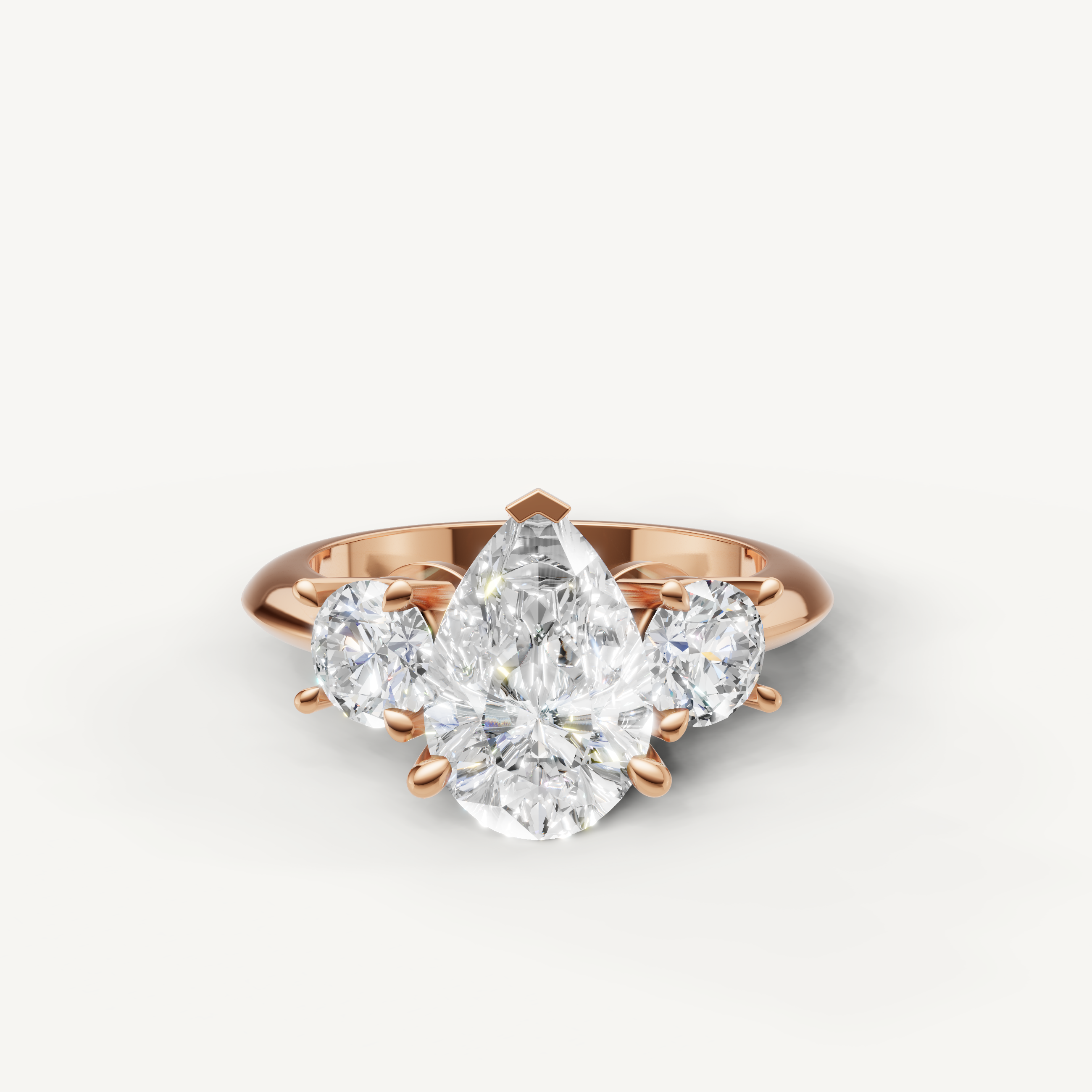 Pear cut three stone lab grown diamond engagement ring in 14K rose gold