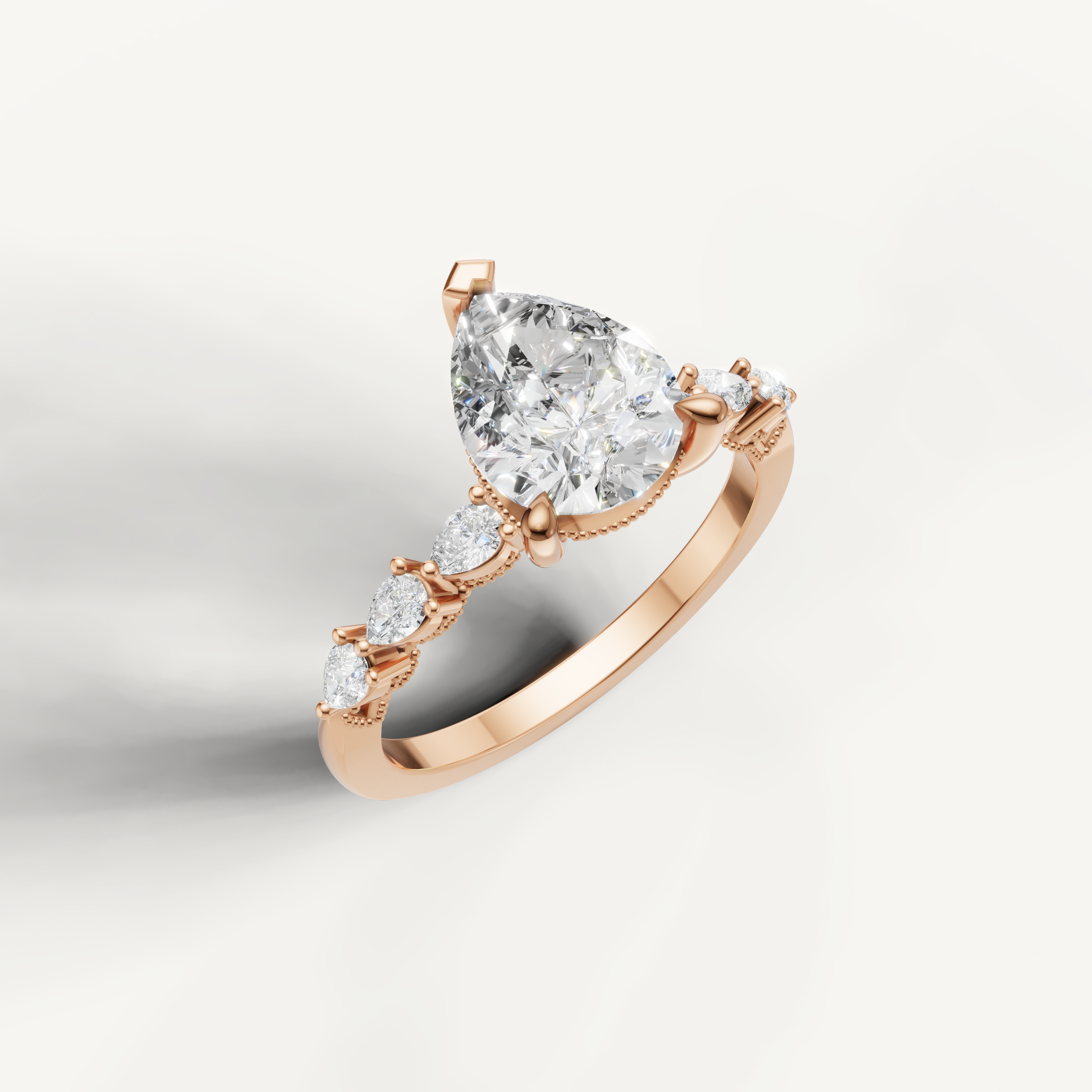 Rose gold pear shaped lab grown diamond ring with marquise diamond accents and elegant nature inspired setting