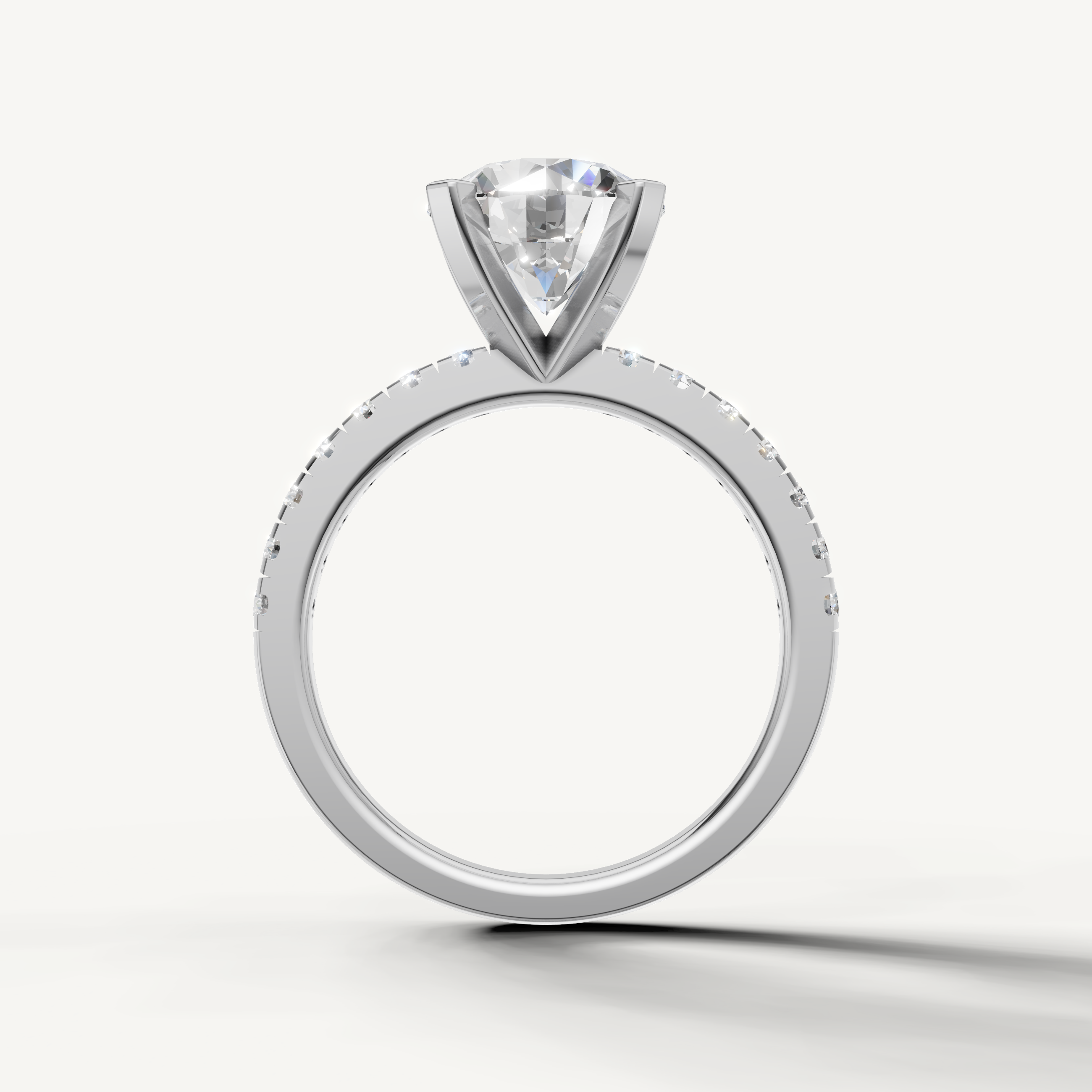 White gold round solitaire ring with sparkling pavé diamonds and classic style.