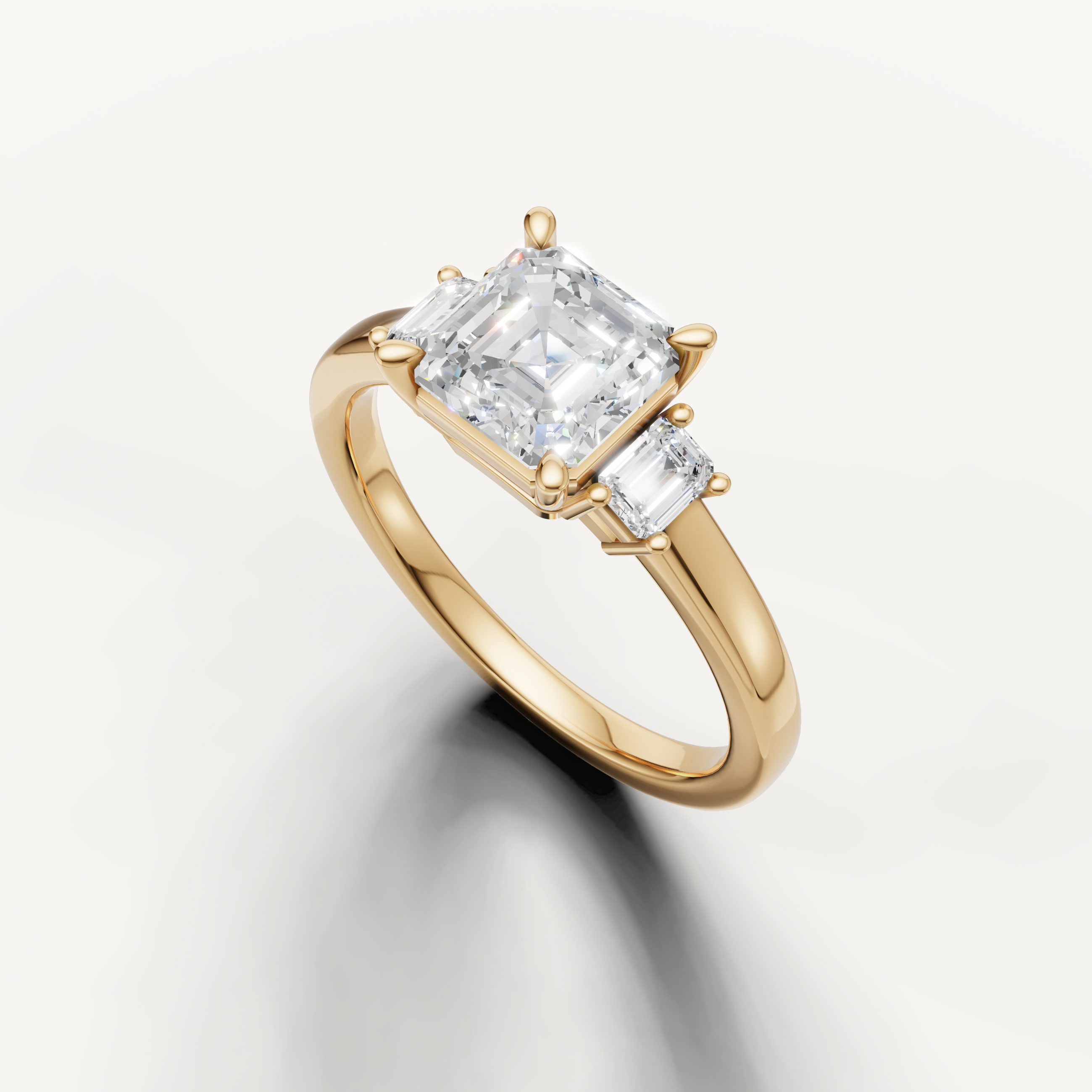 Modern Asscher cut three stone lab grown diamond ring in yellow gold with geometric side stones