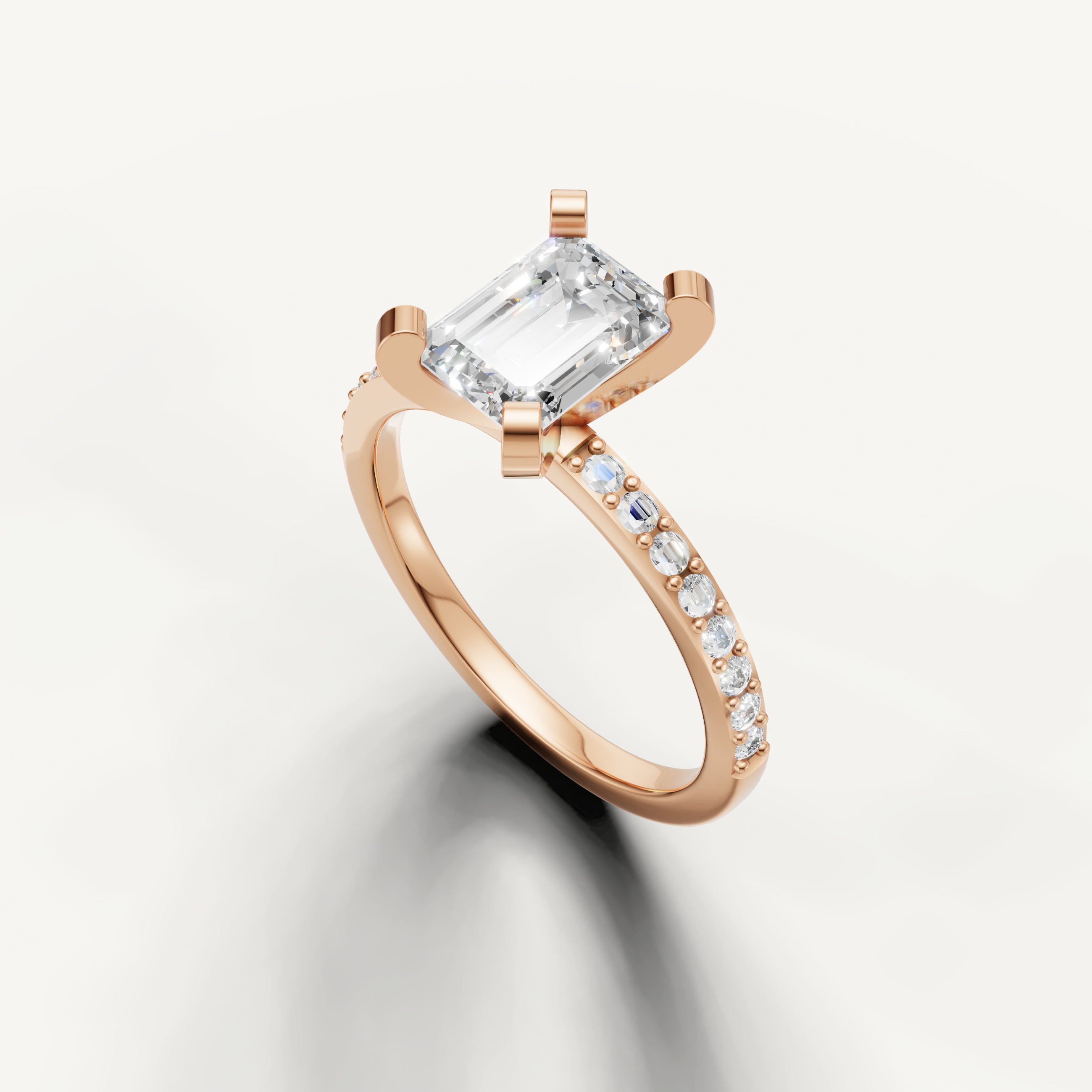 Elongated emerald cut diamond ring in rose gold with micro pavé setting