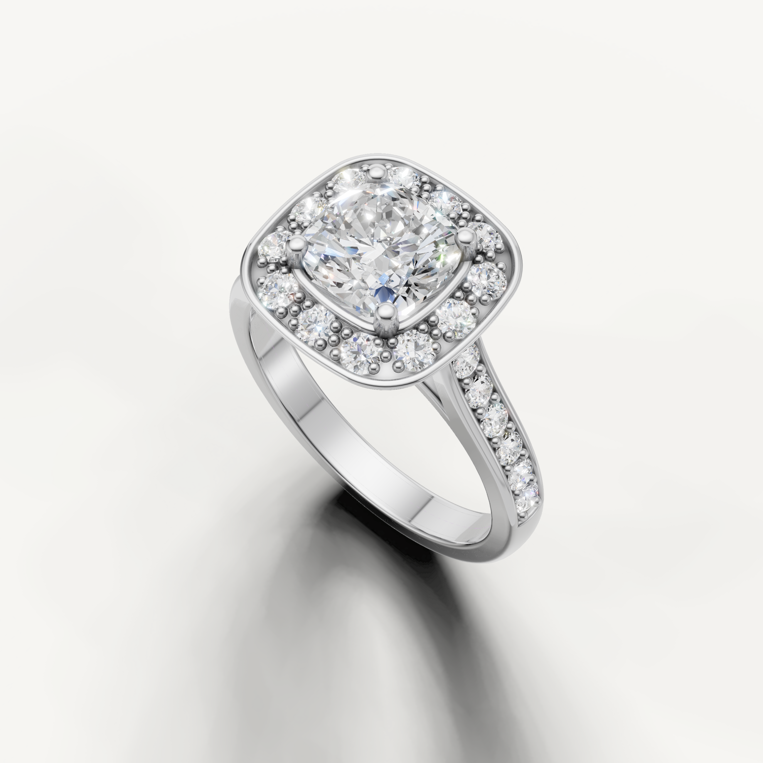 White gold cushion cut engagement ring with pave band and halo setting from Raul Diamonds.