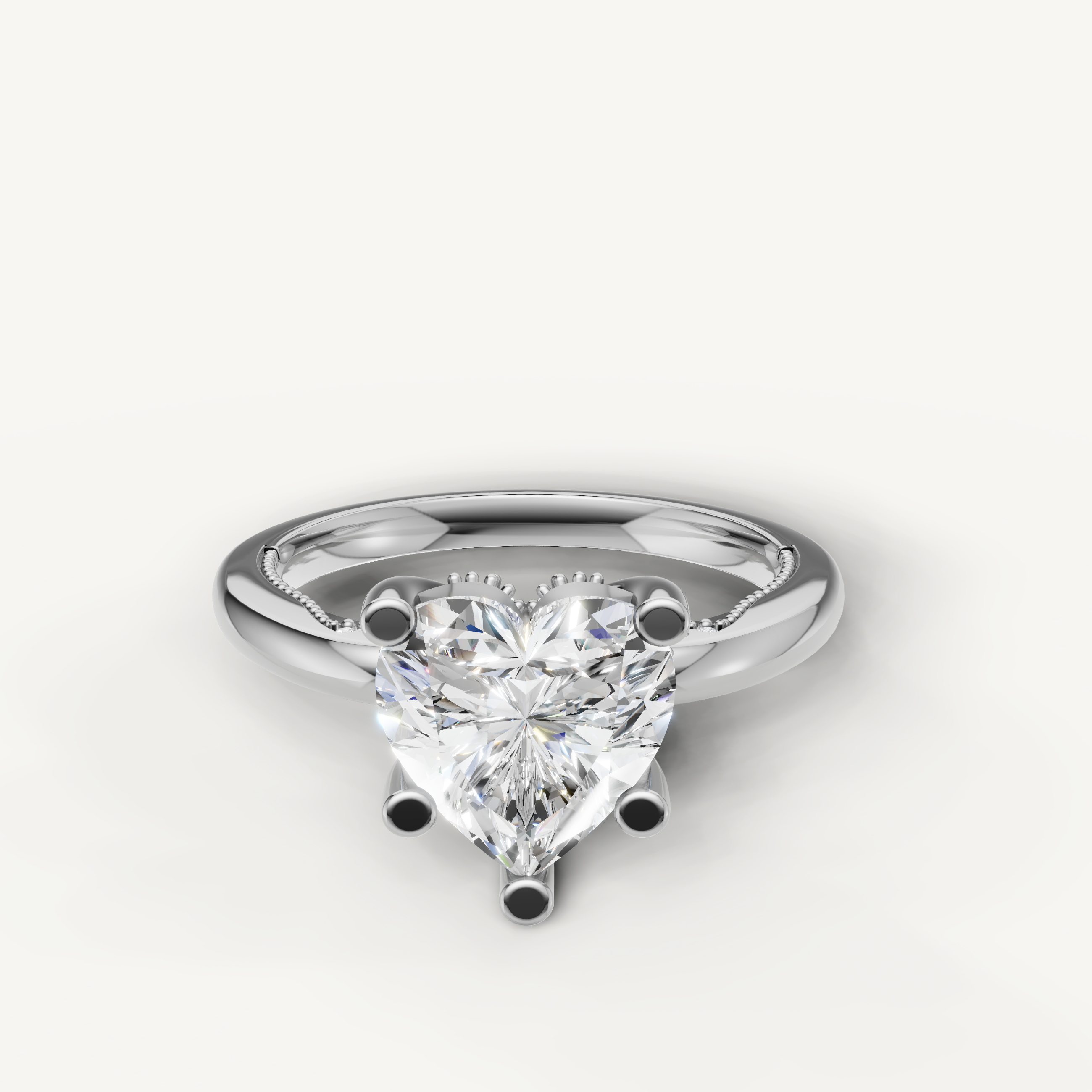 A classic solitaire engagement ring in bright, polished white gold or platinum, featuring a dazzling, high-clarity heart-cut diamond.
