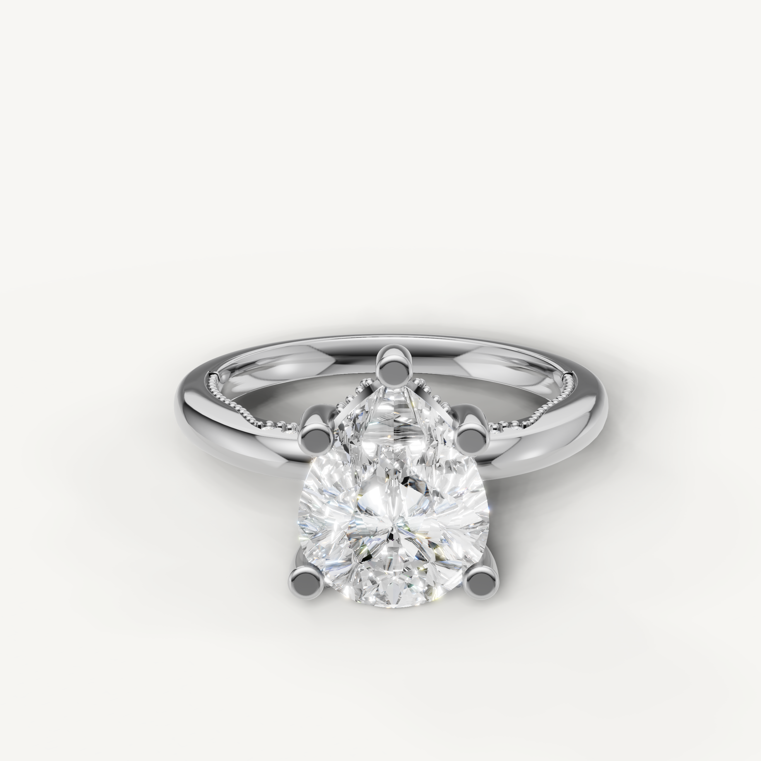 A classic solitaire engagement ring in bright, polished white gold or platinum, featuring a dazzling, high-clarity pear-cut diamond.