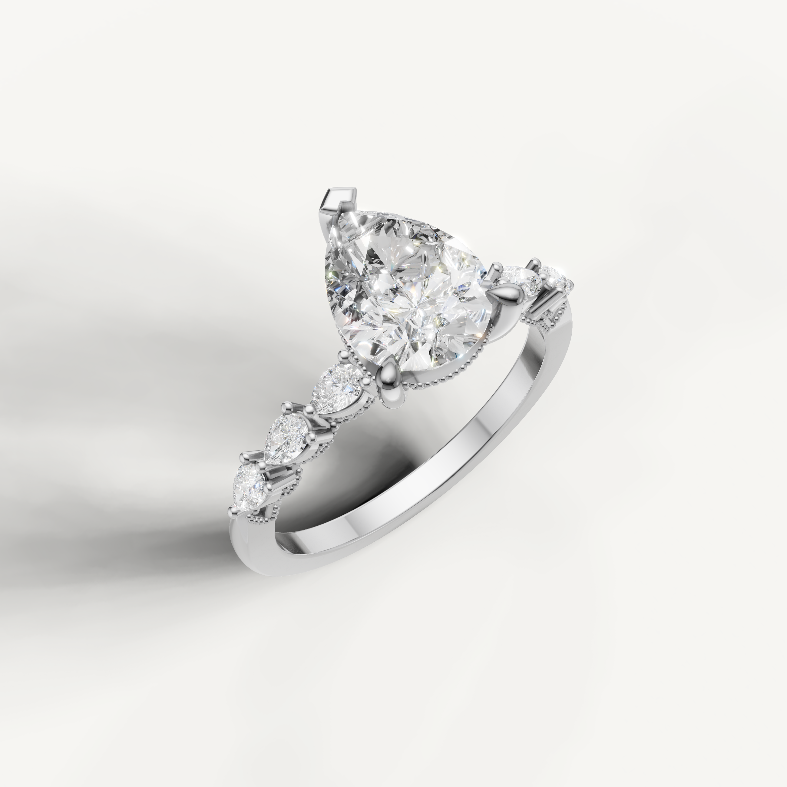 White gold pear shaped lab grown diamond ring with marquise diamond accents and elegant nature inspired setting