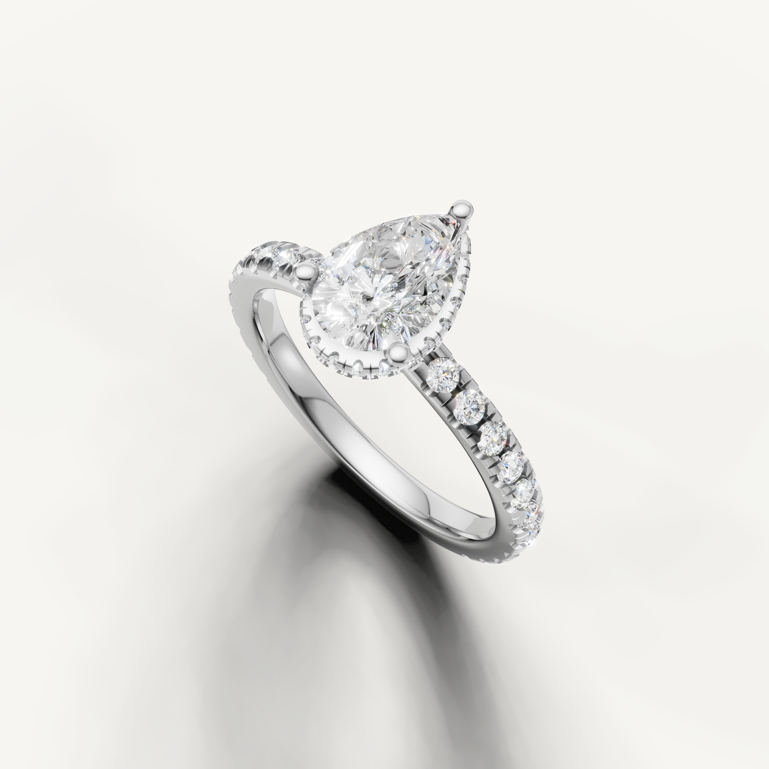 14k white gold pear cut lab grown diamond engagement ring featuring hidden halo detail and pavé diamond shank