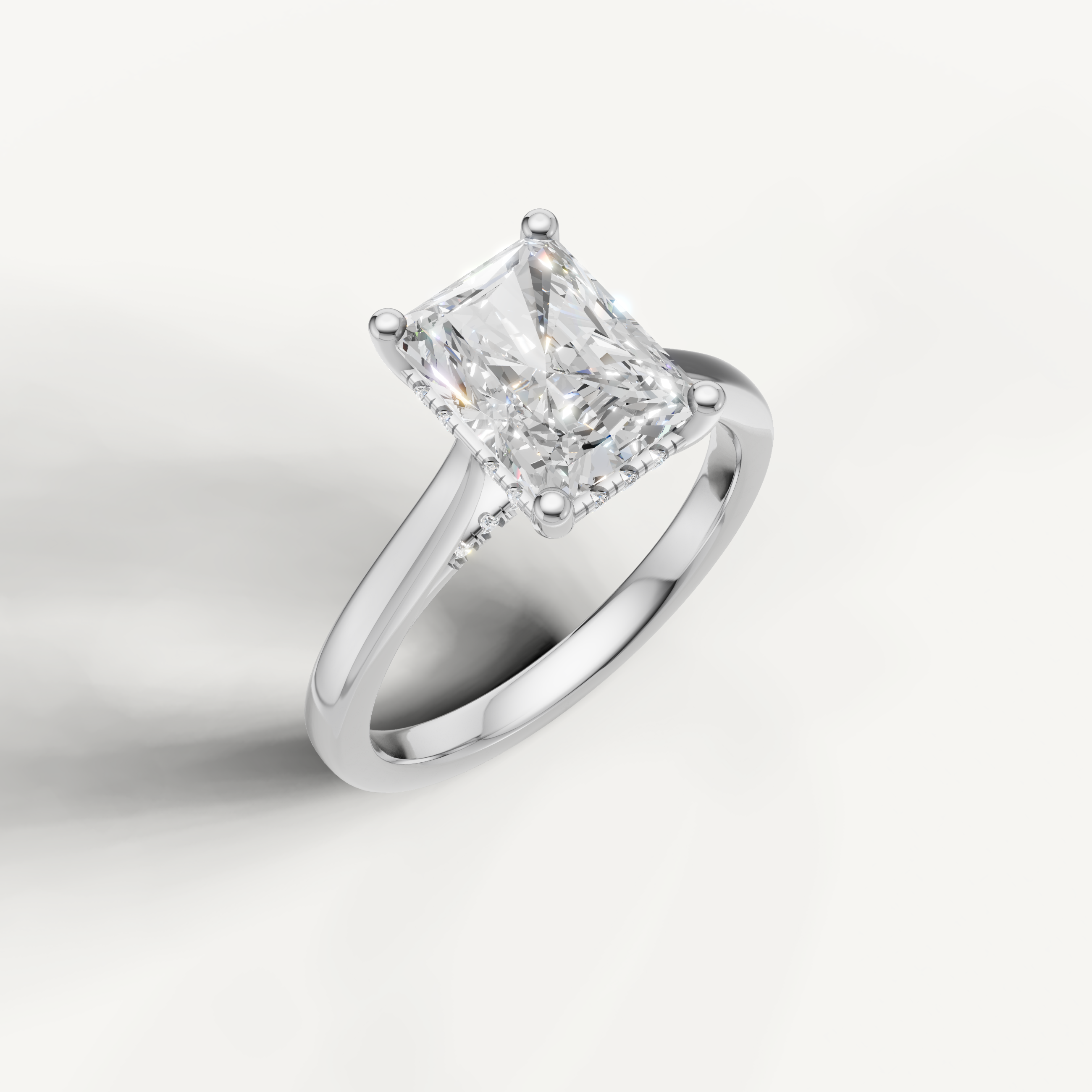 White gold radiant-cut lab-grown diamond solitaire ring with pavé hidden halo setting