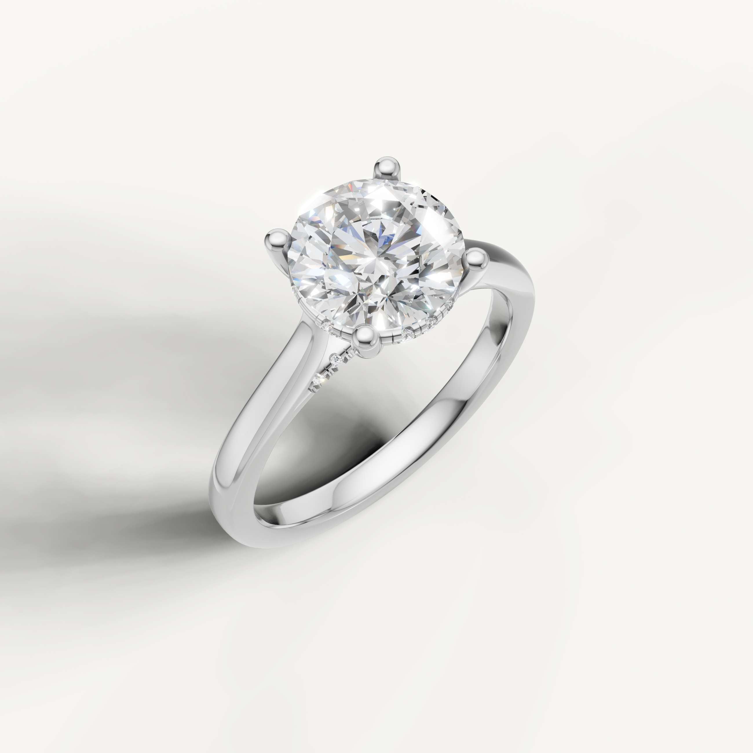 White gold round-cut lab-grown diamond solitaire ring with pavé hidden halo setting