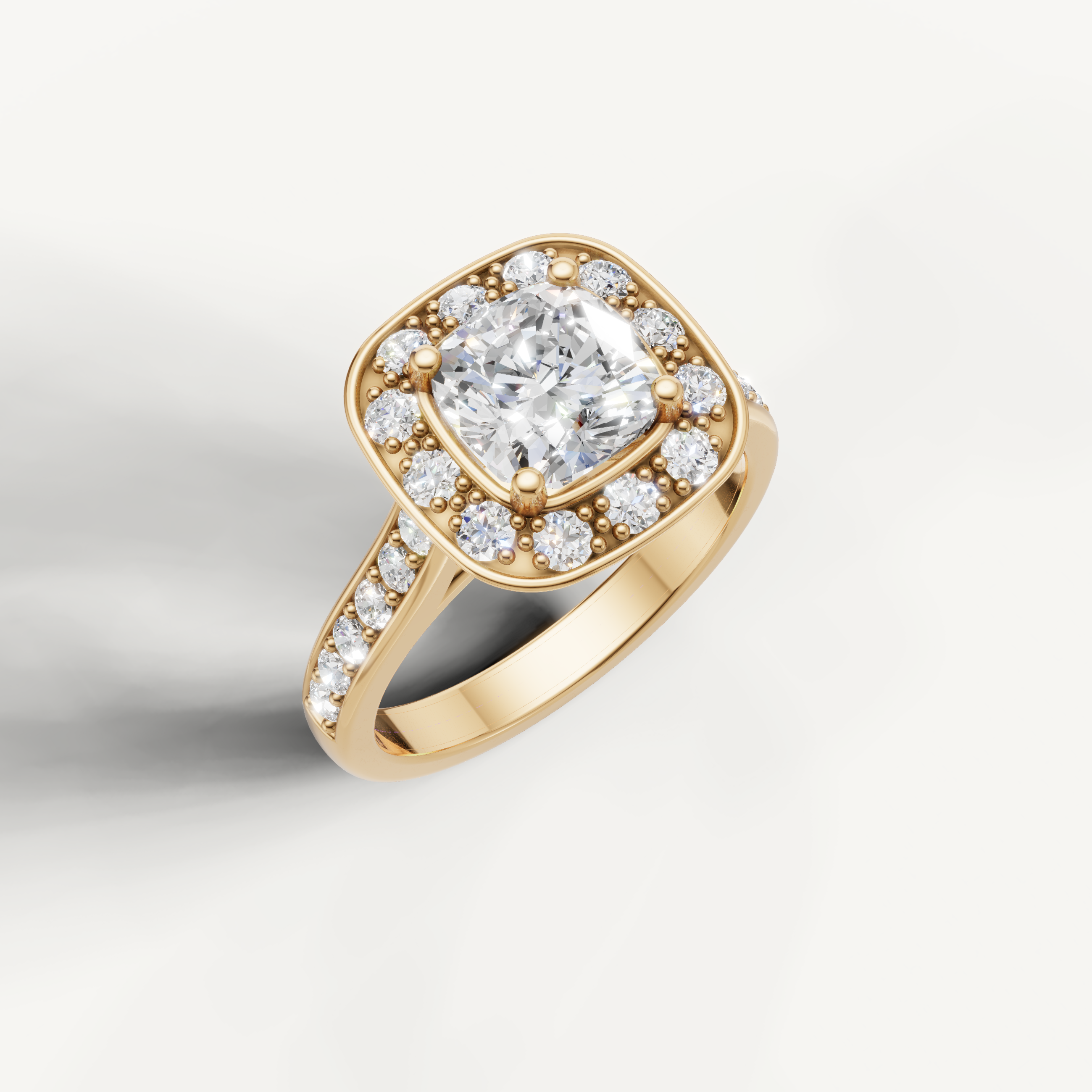 Close-up of yellow gold cushion halo diamond ring with pave band from Raul Diamonds.