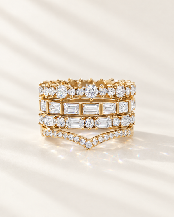Stack of four lab-grown diamond wedding bands in 14K yellow gold