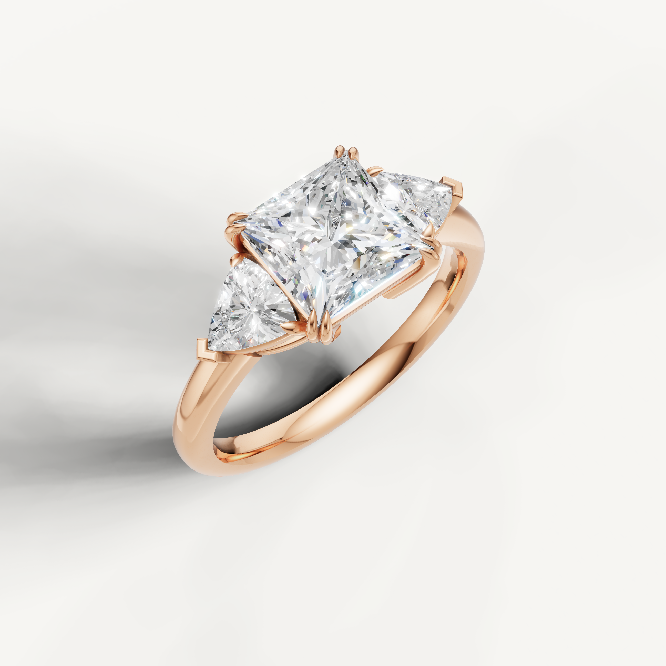 romantic princess cut lab grown diamond trilogy ring with tapered trillion side diamonds