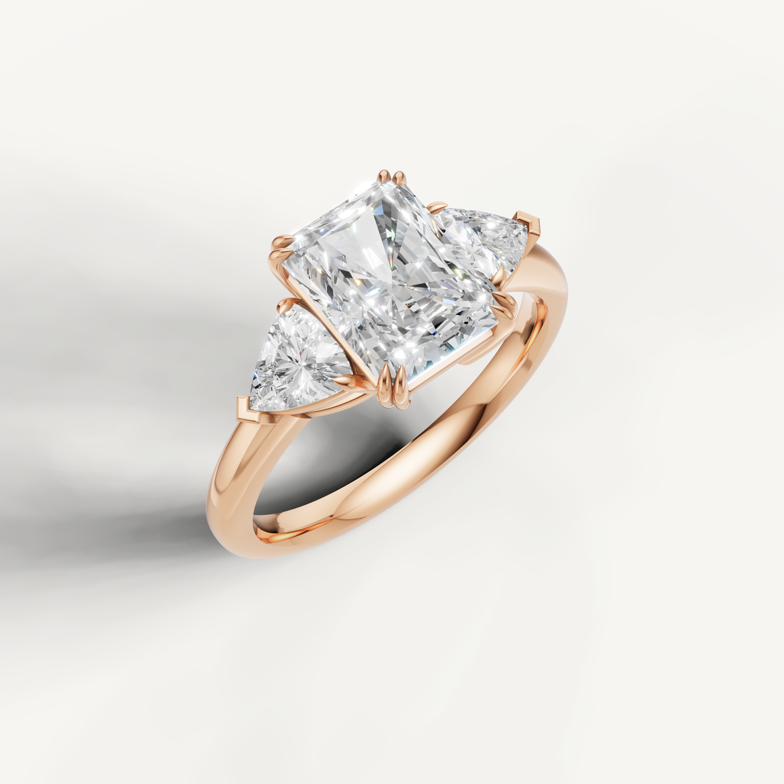 romantic radiant cut lab grown diamond trilogy ring with tapered trillion side diamonds