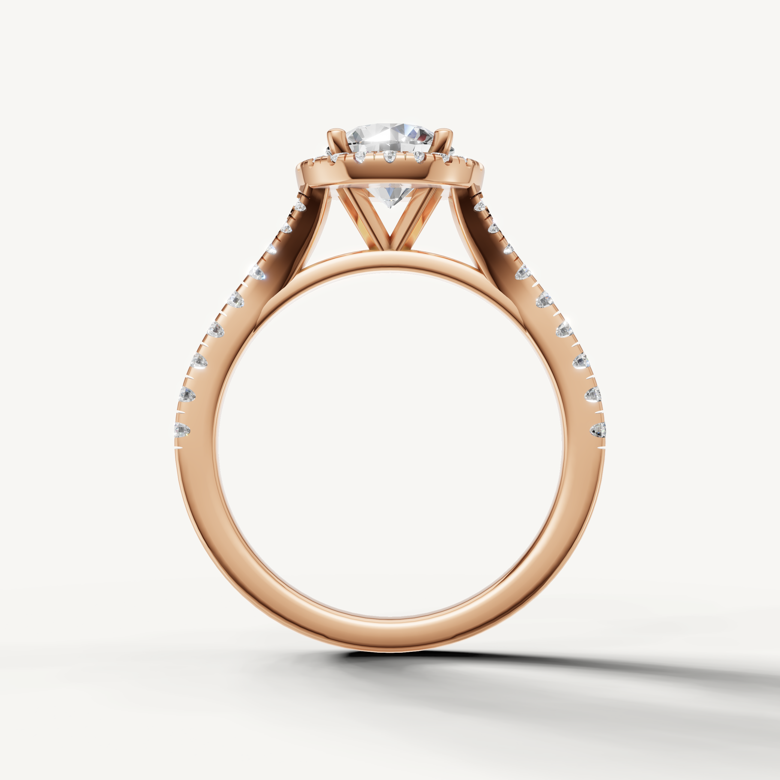Round cut engagement ring with halo and pavé band rose gold