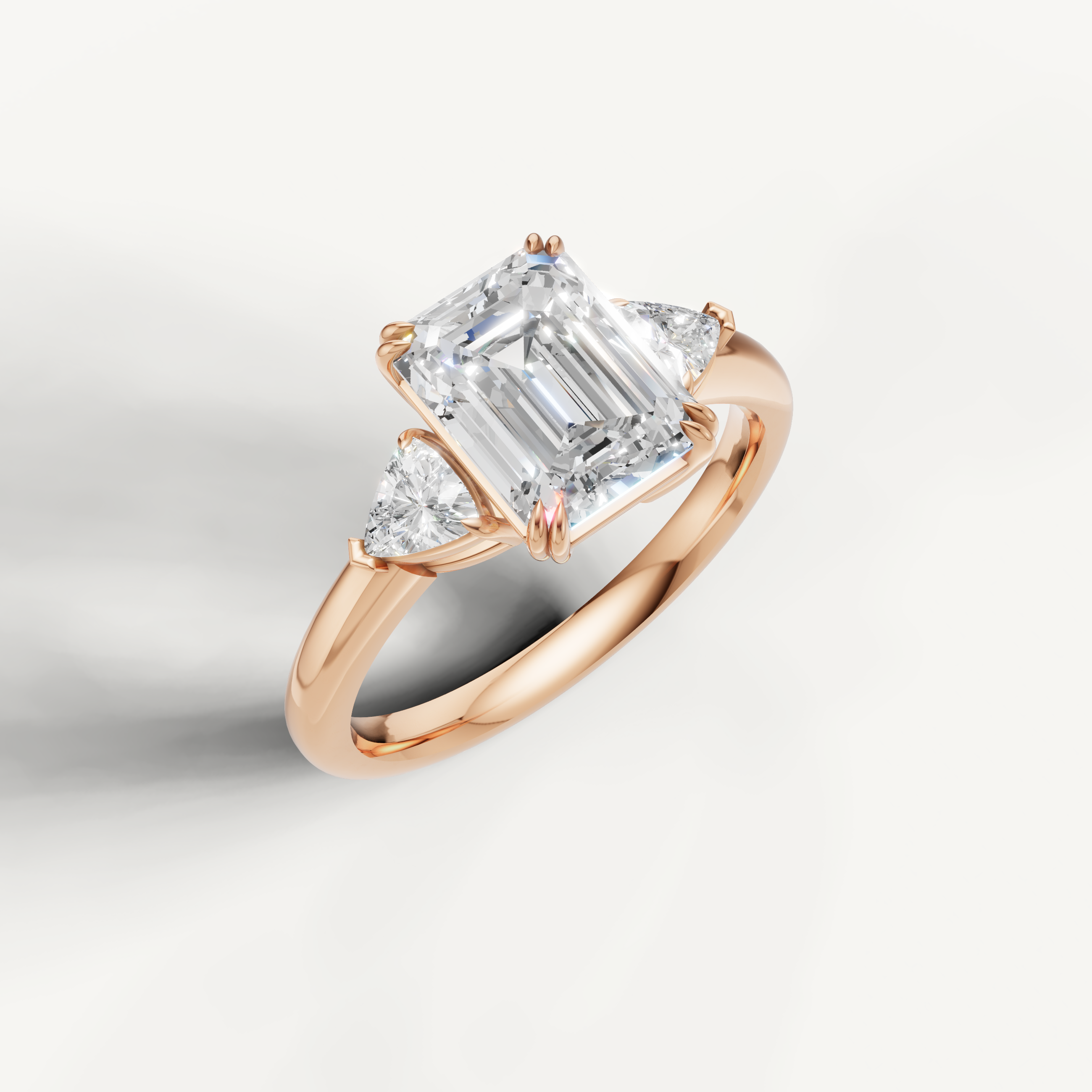 elegant emerald cut lab grown diamond ring with sparkling trillion side accents in rose gold
