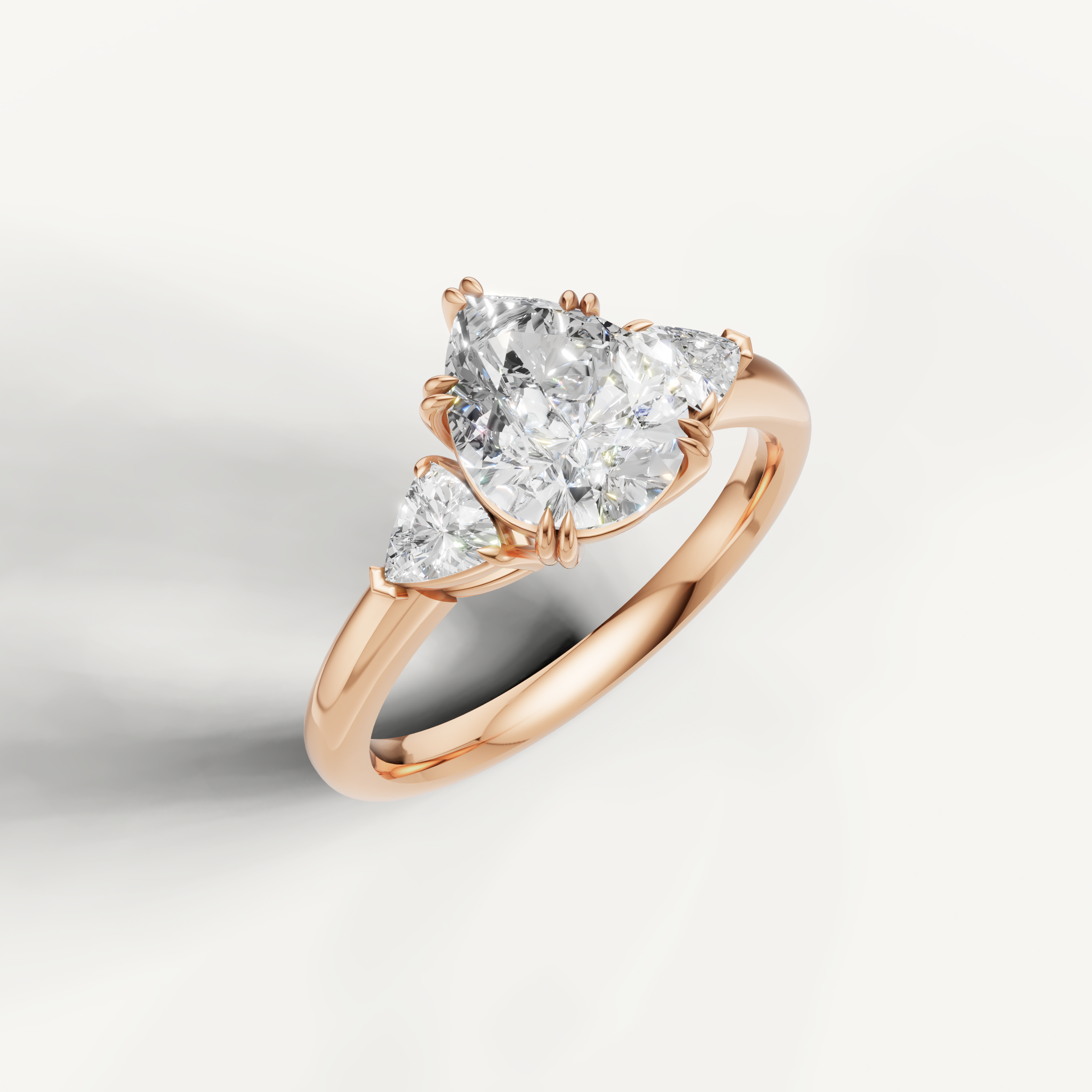 romantic pear shaped lab grown diamond trilogy ring with tapered trillion side diamonds