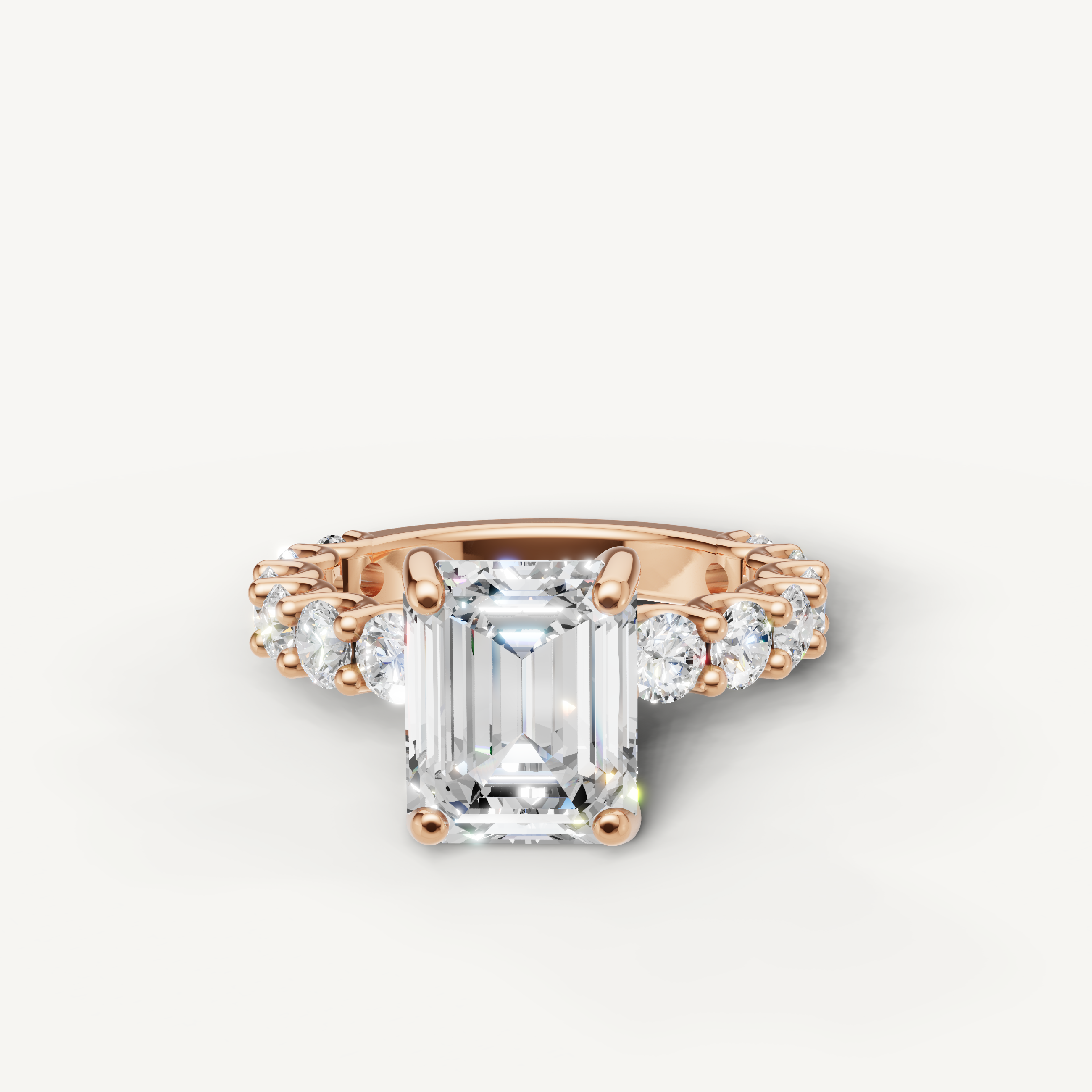 Emerald cut lab grown diamond engagement ring with shared prong side stones in 14K rose gold