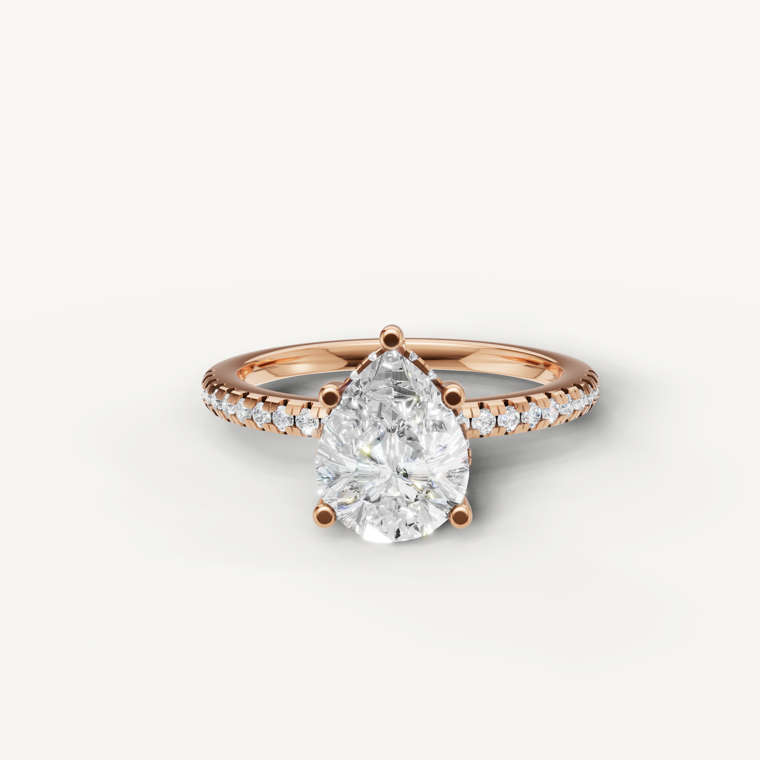 pear cut lab grown diamond engagement ring with pavé band in 14k rose gold