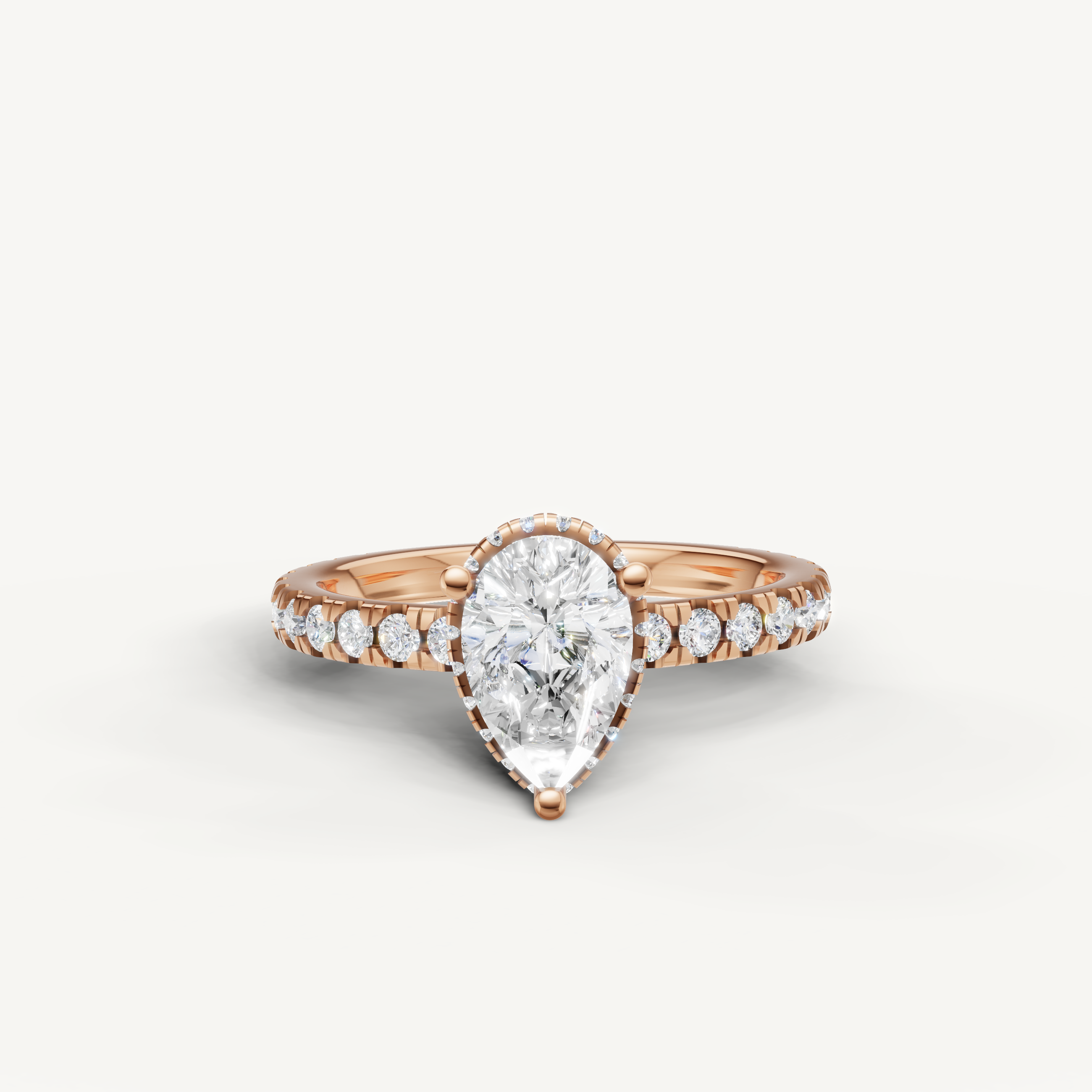 pear cut lab grown diamond hidden halo engagement ring in 14k rose gold with shimmering pavé diamond band